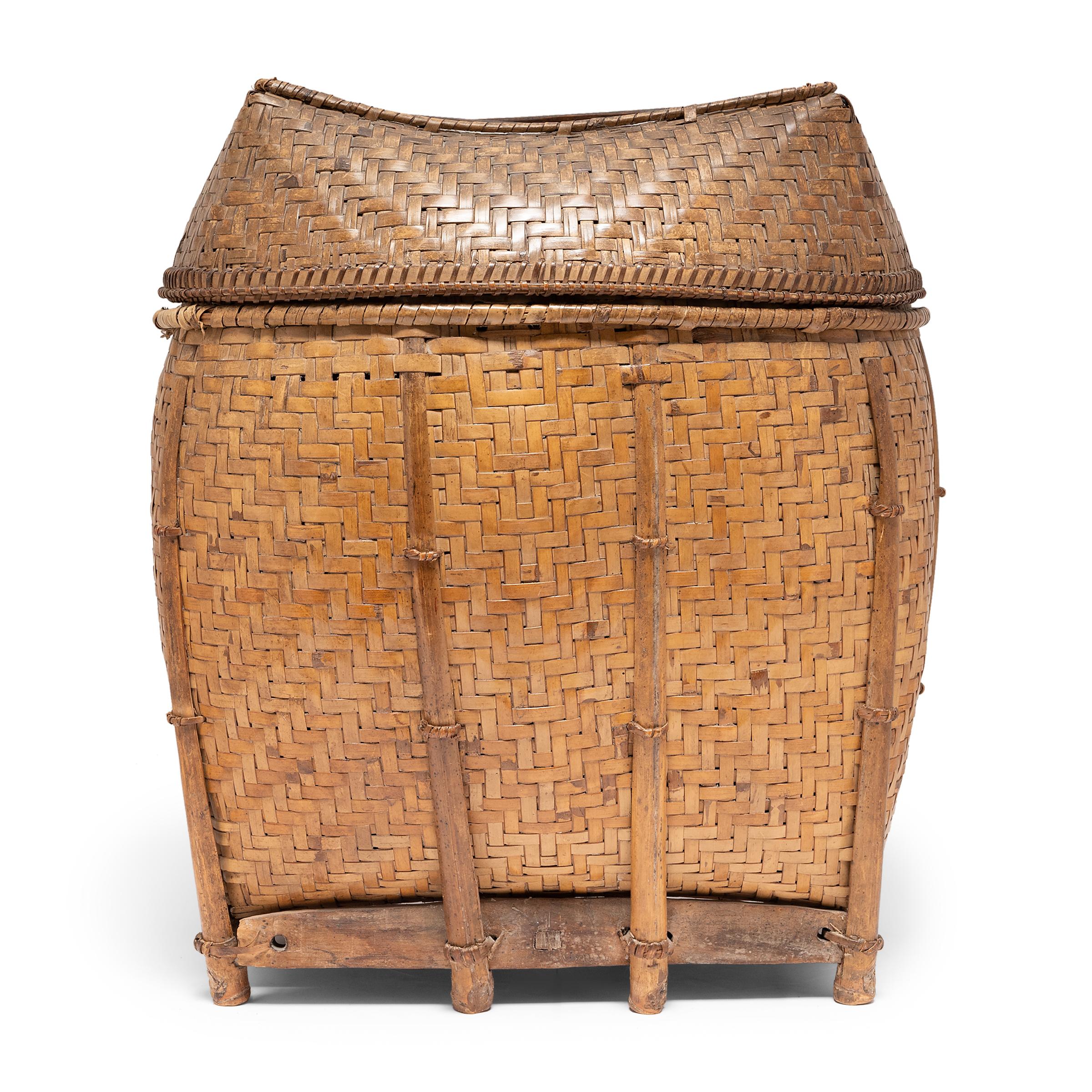 Basket making is an ancient and humble craft, but in the hands of a skilled weaver a simple reed basket can become a truly beautiful work of art. Hand-made in the Philippines, this lidded basket was once used for harvesting crops or carrying