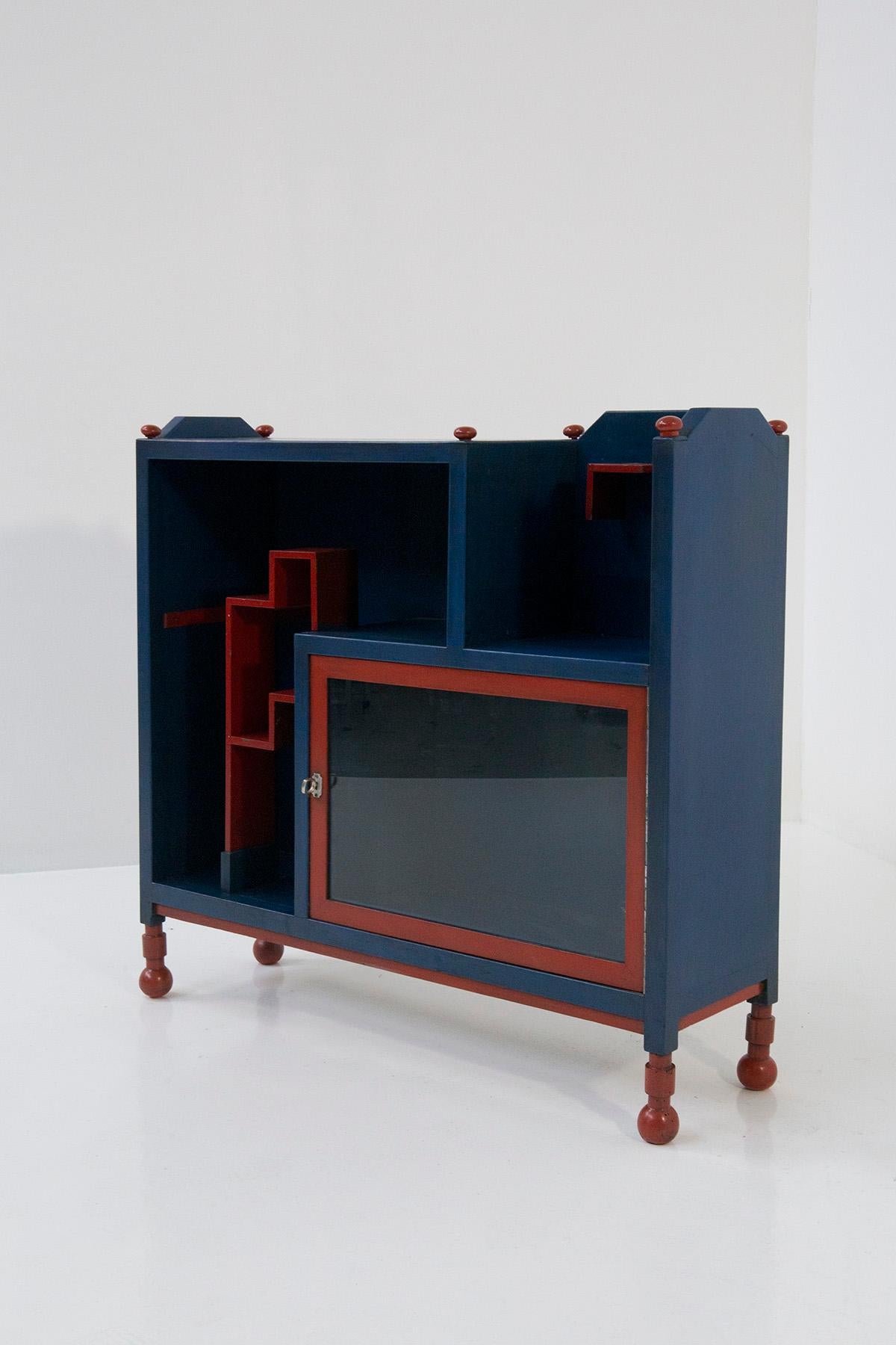 The evocative allure of the rare Italian Futurist sideboard attributed to Fillìa Luigi Colombo beckons us to delve into its captivating details. This exquisite piece, crafted from wood and adorned with a vibrant fusion of blue and red hues, stands