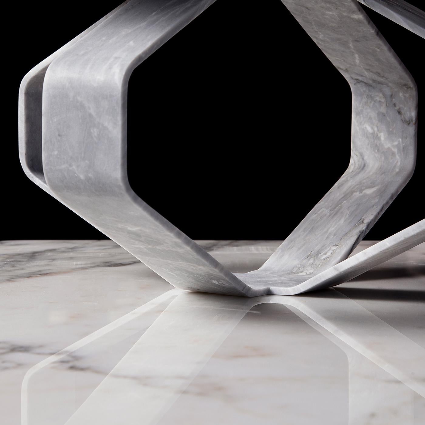 Conflicting geometric volumes are smartly balanced in this coffee table fashioned of top-rate Versilys marble that will add a captivating accent in any contemporary decor. Flattened marble slabs, meeting at the base and marked by a severe profile