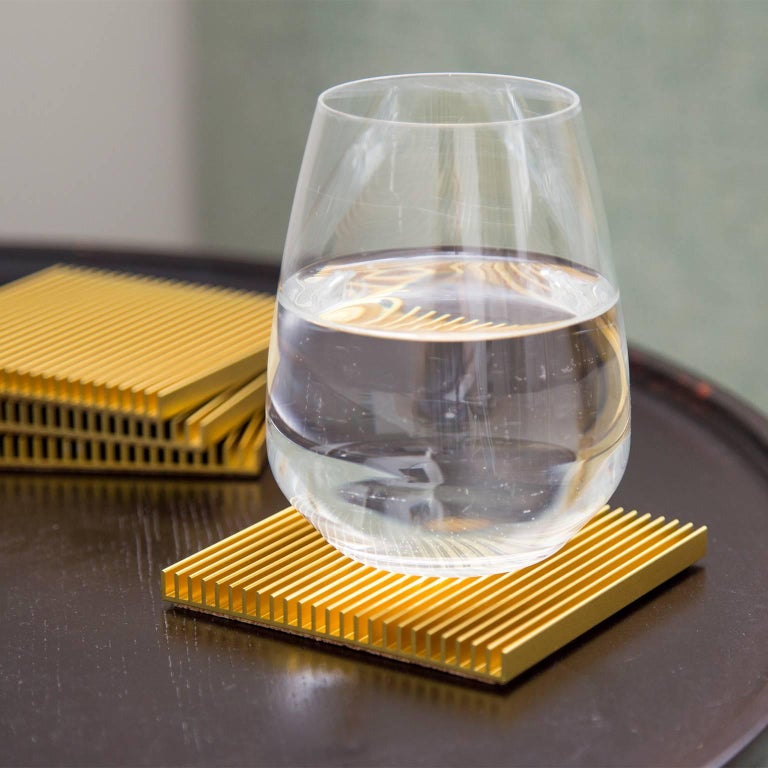 Slim, architectural, and refined, the Fin coasters are a decidedly modern approach to a traditional tabletop accessory. Designed by Shaun Kasperbauer, the coasters are produced through a unique partnership with a manufacturer of Industrial heat
