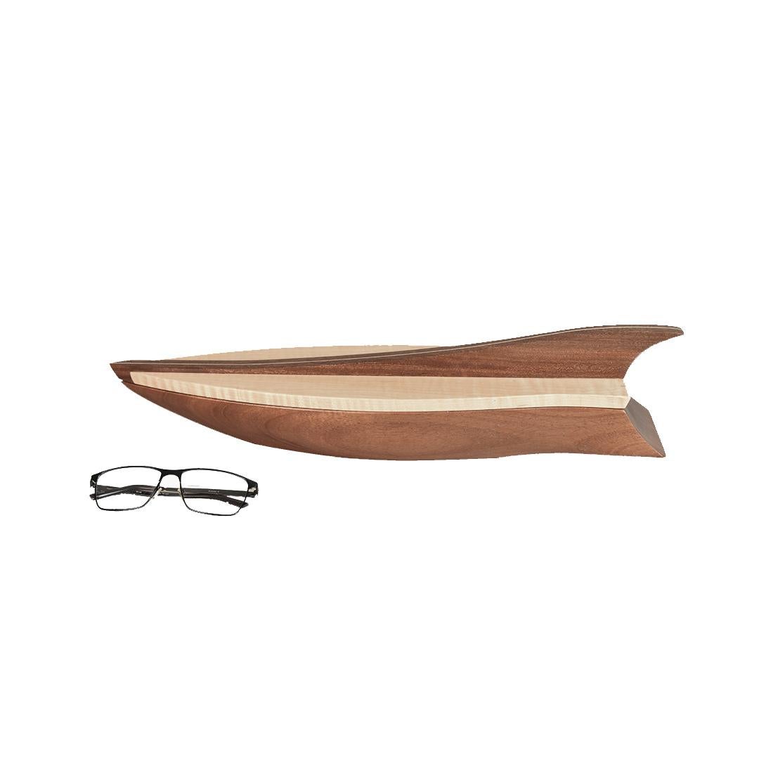 This one-of-a-kind carved wooden sculptural vessel was hand made, signed and dated, by Lee Weitzman. The natural curly maple lid with mahogany and maple fin handle lifts off to show a small storage compartment. The boat shaped bottom portion 