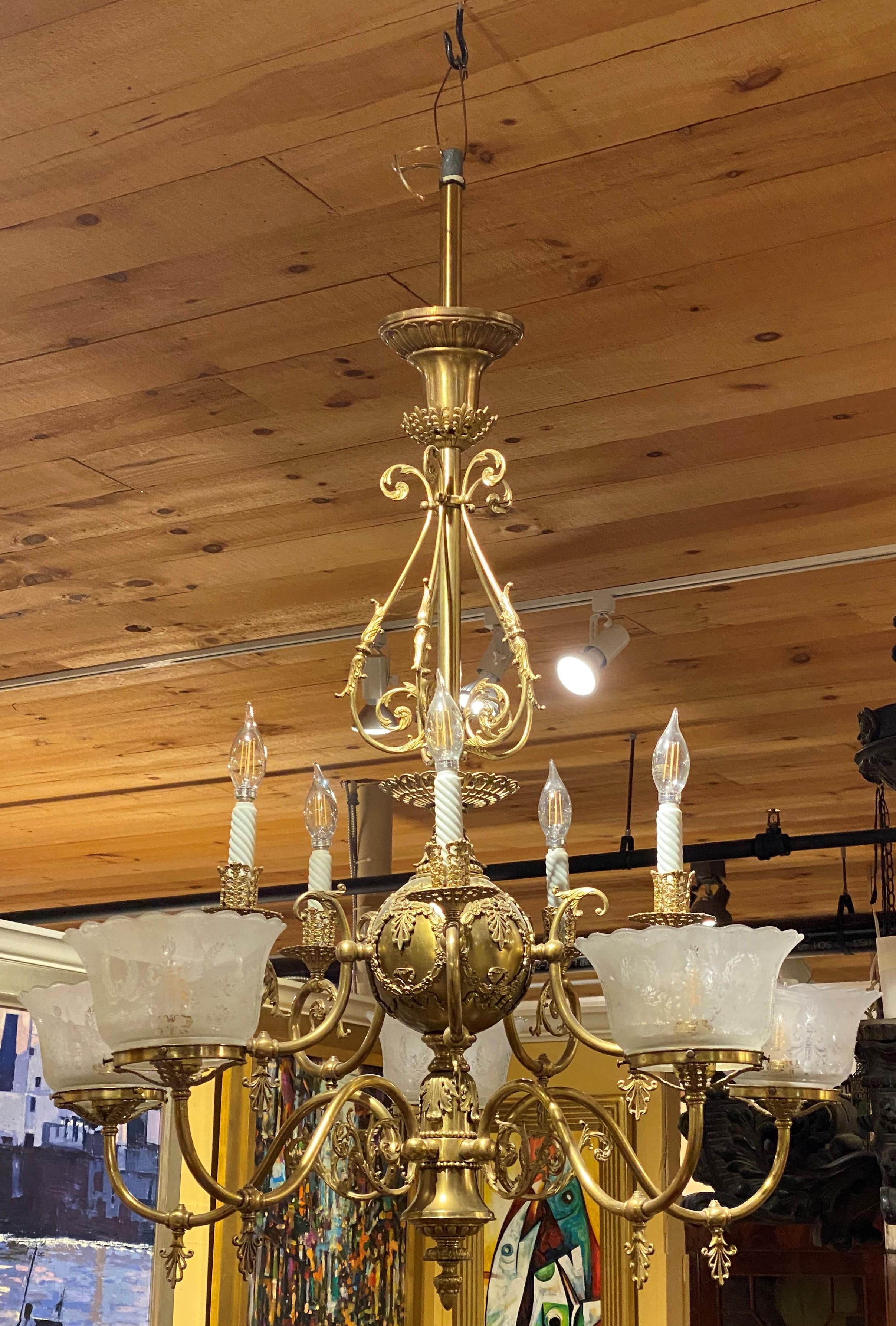 A fine 10-light two tier brass gasolier / chandelier that has been recently electrified with 5 upper candle lights and 5 lower lights extended on scrolled arms, with ruffled edge etched shades, around a decorated center ball with single drop or