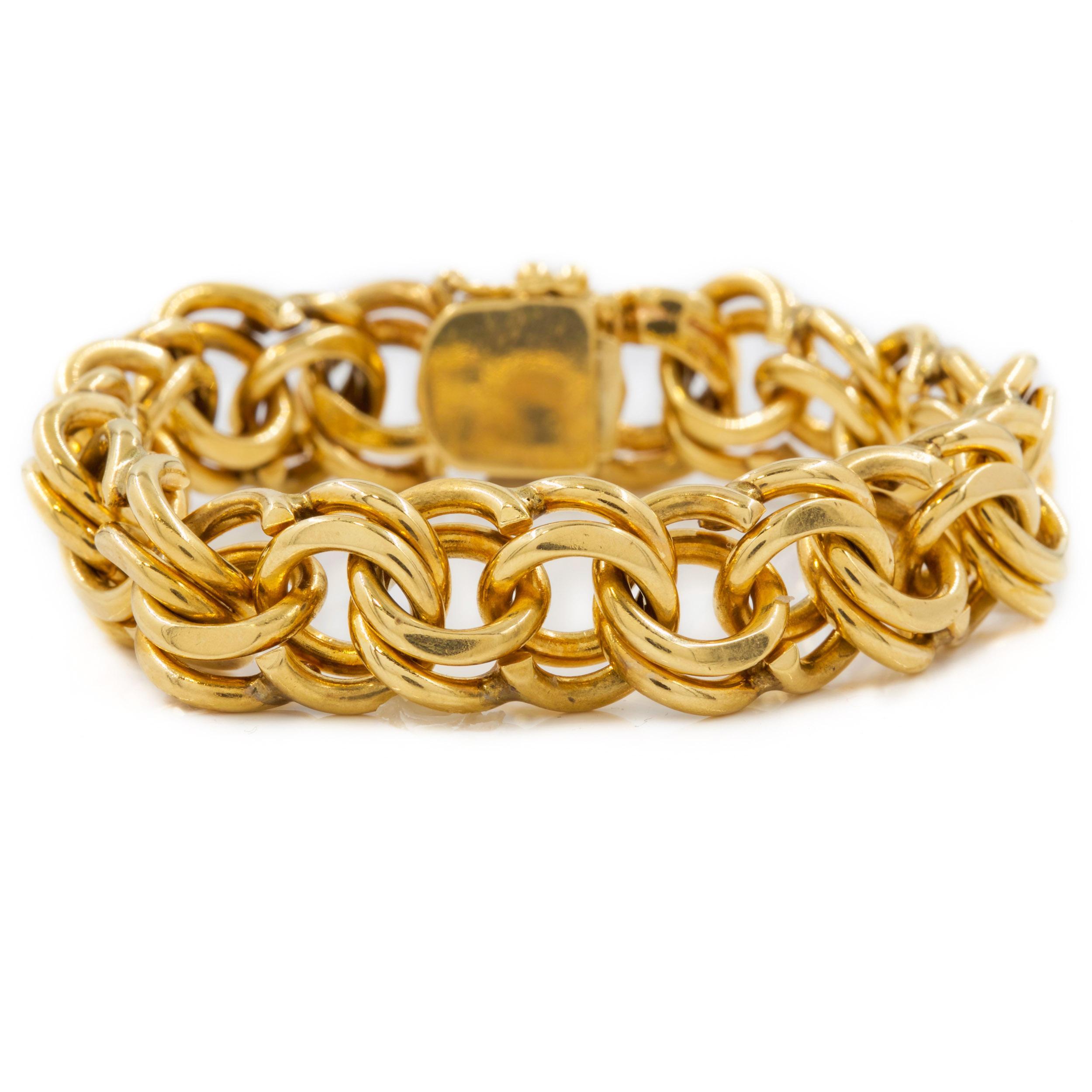 An incredibly substantial and heavy circular double-link bracelet crafted of 74.4 grams of solid 14 karat gold, this gorgeous everyday piece is as comfortable as it is eye-catching. It is a clever design with what appears to be a series of twisted