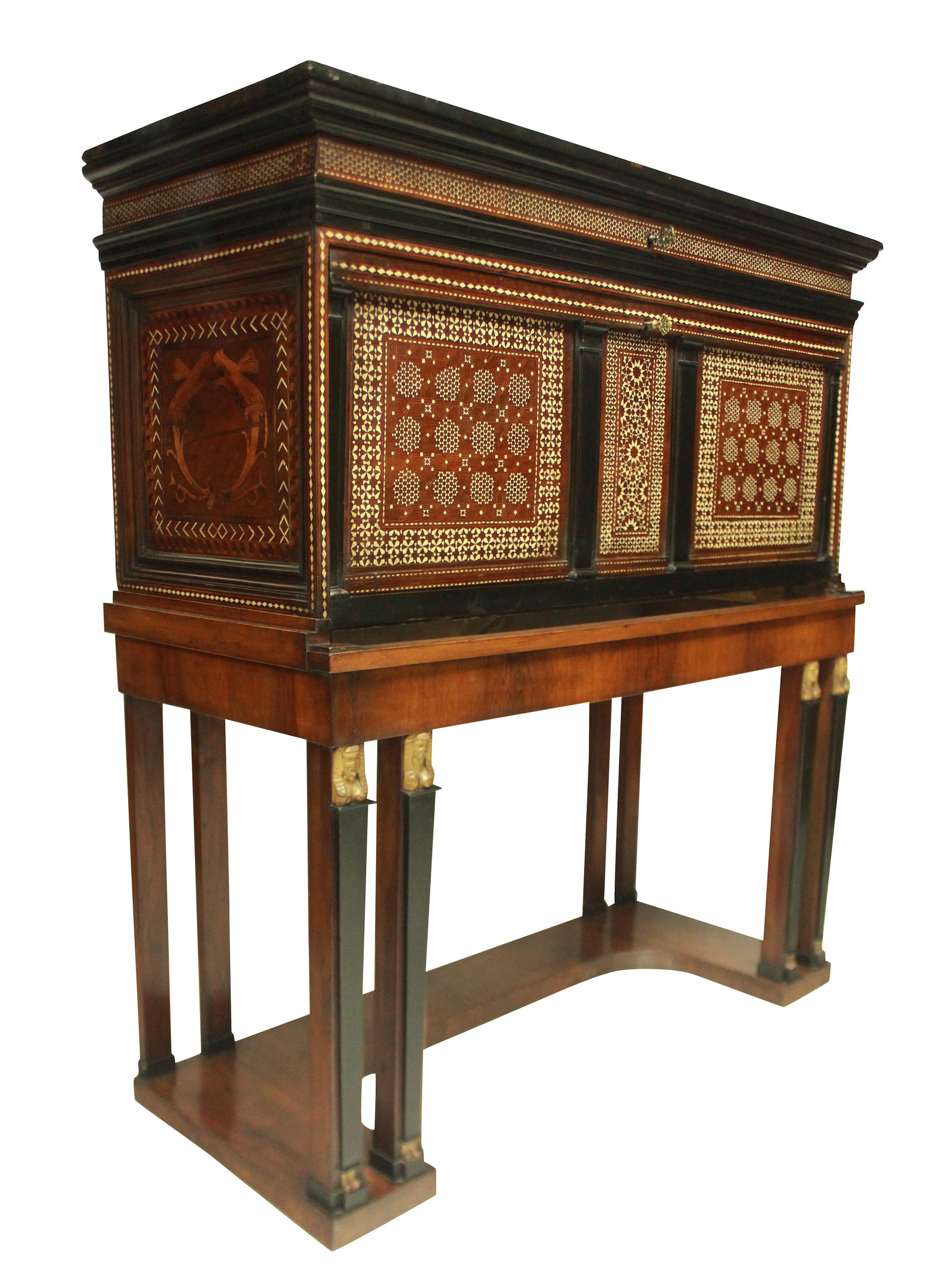 A fine Spanish Vargueno cabinet on stand in the Moorish taste, beautifully inlaid both inside and out with bone in geometric patterns and stylized beasts to the sides. The inside with compartments and a fall front writing slope and a lockable
