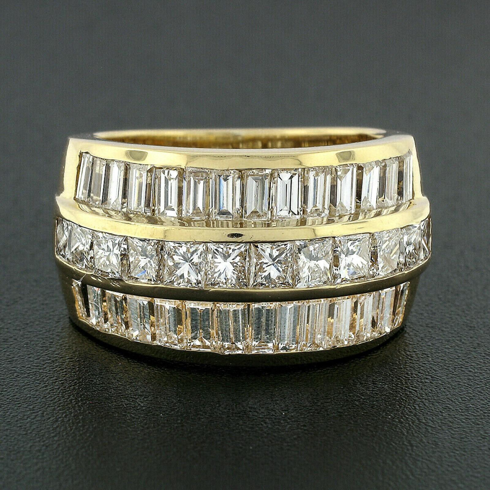 This is a super impressive, vintage statement band ring crafted in solid 18k yellow gold featuring 3 rows of magnificent diamonds across its solidly made triple channel design. The center row is slightly raised above the outer borders, showcasing 12