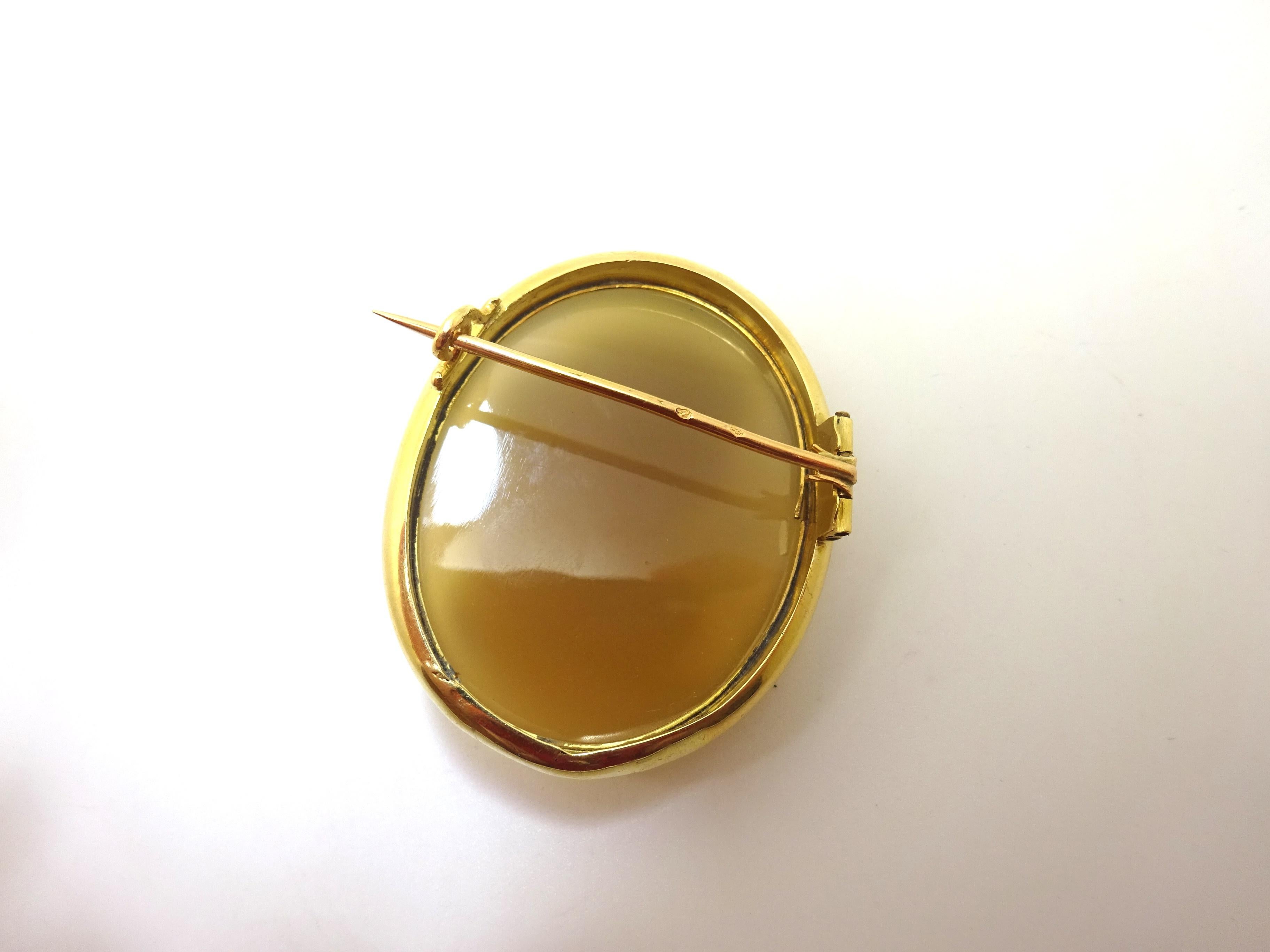 Rare 19th Century 18k yellow gold high relief hard stone cameo pin. The fabulous high relief hand carved banded brown and white agate stone measures 42.4mm x 33.5mm. The pin measures 1 7/8