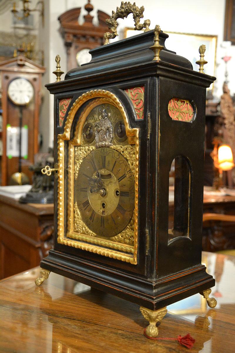 18th century, quarter-hour console clock. Made circa 1780 in England or Austria.

Very richly decorated both inside and outside - please pay attention first of all to the silver plated application with the figure of Saint Nepomuk or the richly