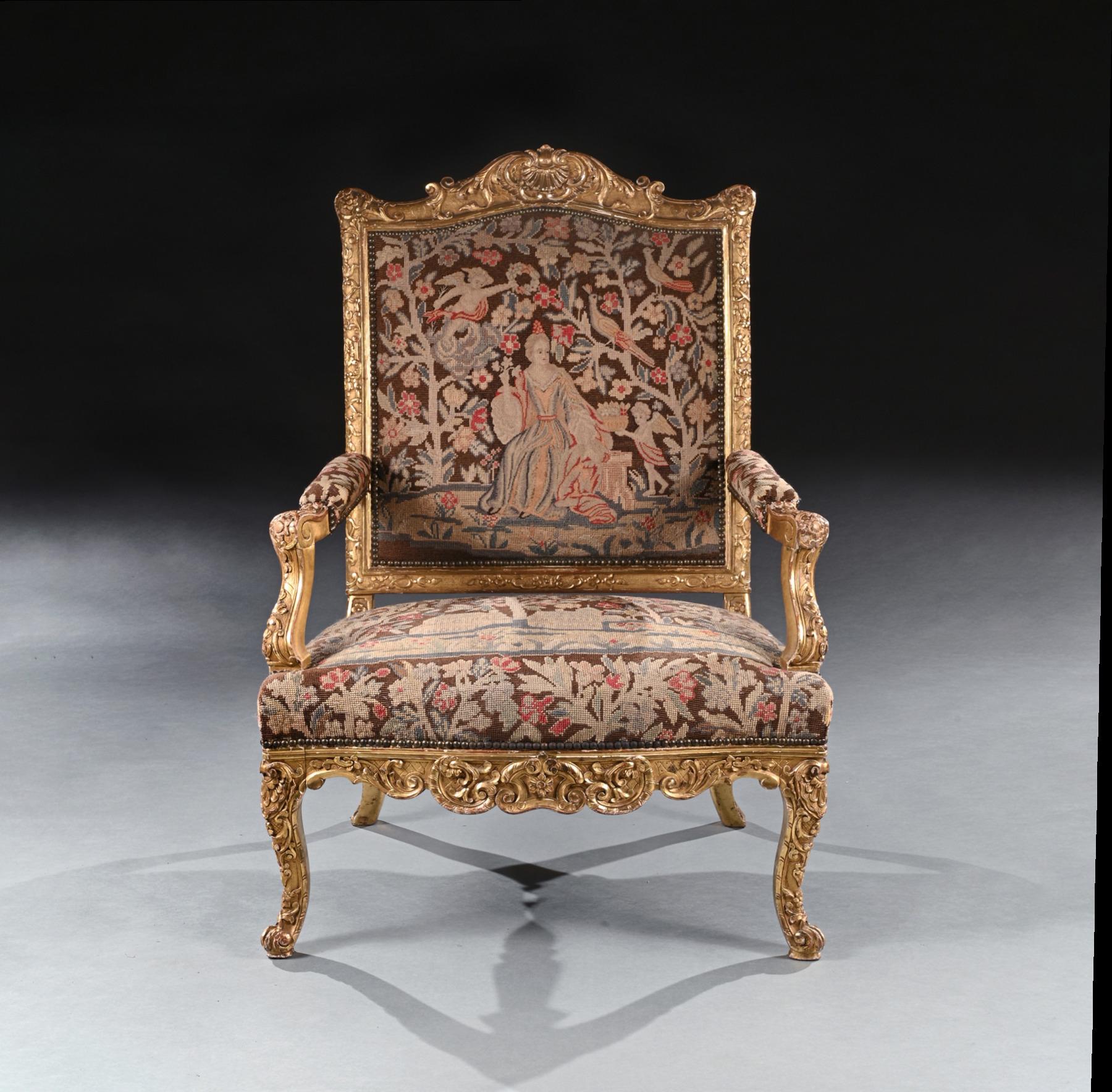 A highly impressive rare French carved Régence period giltwood fauteuil / armchair of imposing proportions with needlework upholstery.

French - circa 1715

Of grand scale, this wonderfully drawn armchair has a shaped and arched carved cresting