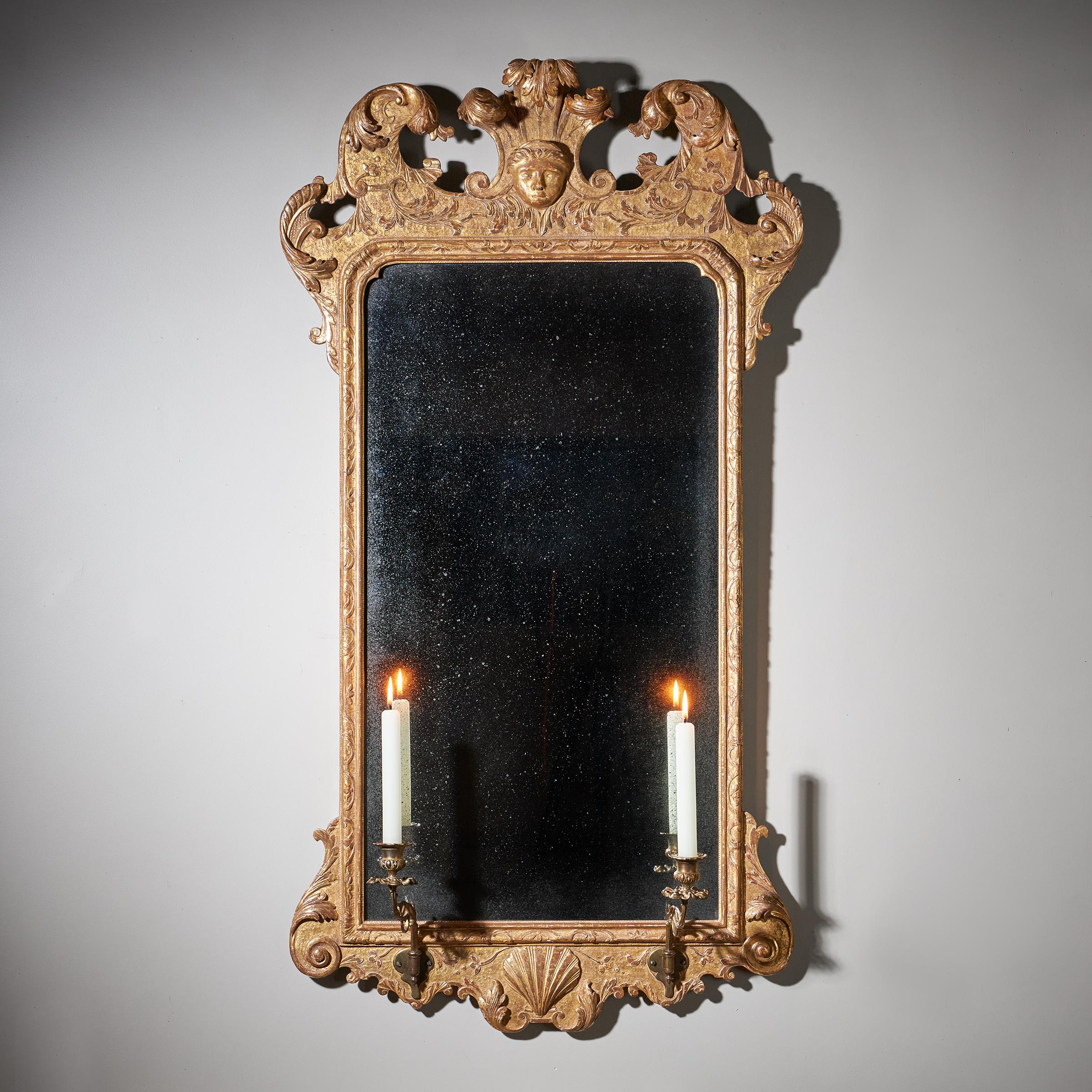 A fine and rare early 18th century George I Gilt Gesso pier or console mirror. 

In the manner of John Belchier

The shaped bevelled mirror plate sits within an upright rectangular moulded frame decorated with Fine leaf carving, lobed corners