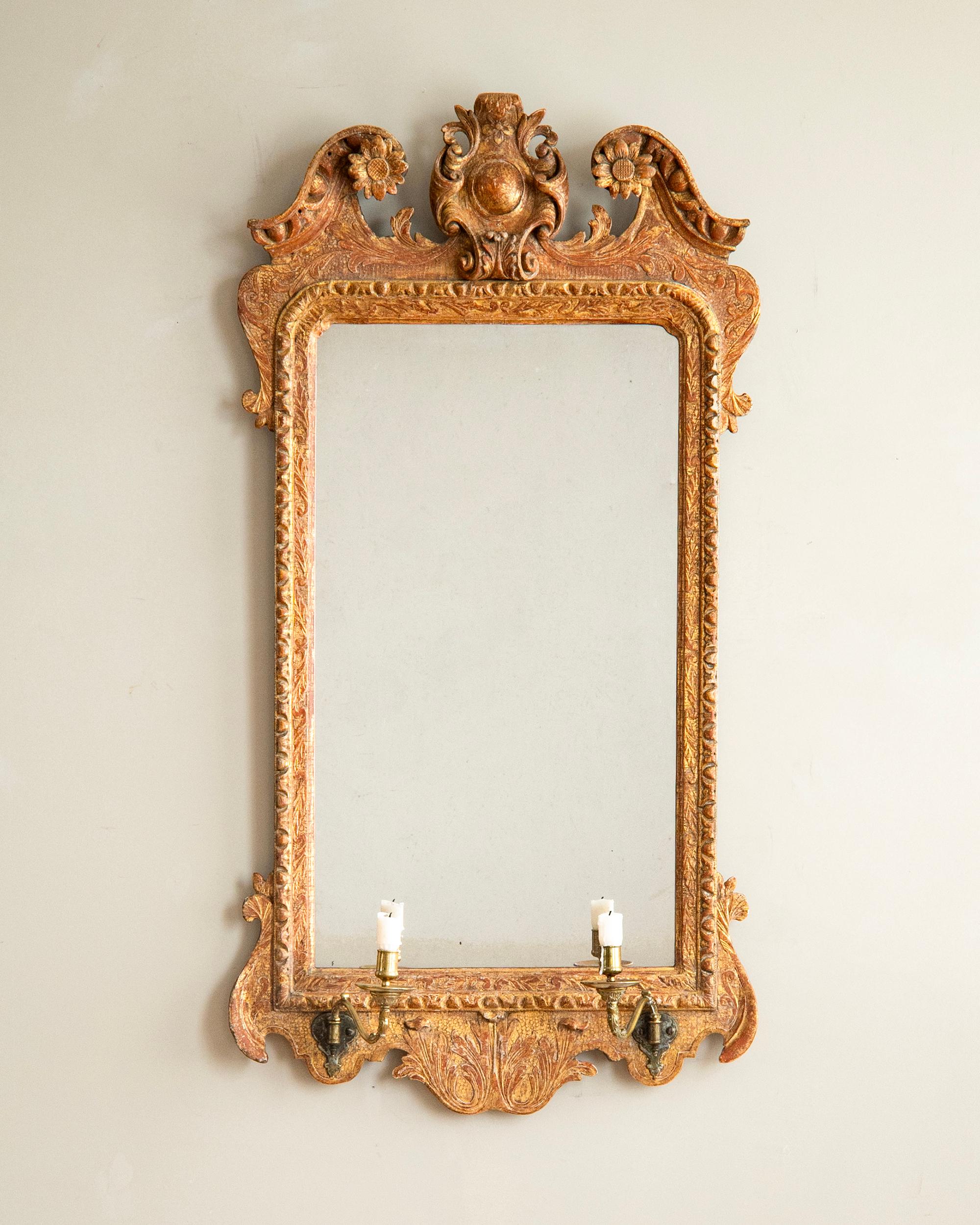 Rare George II carved gilt-wood mirror with brass candle sconces with great patinated surface. ca 1740s, England. 
