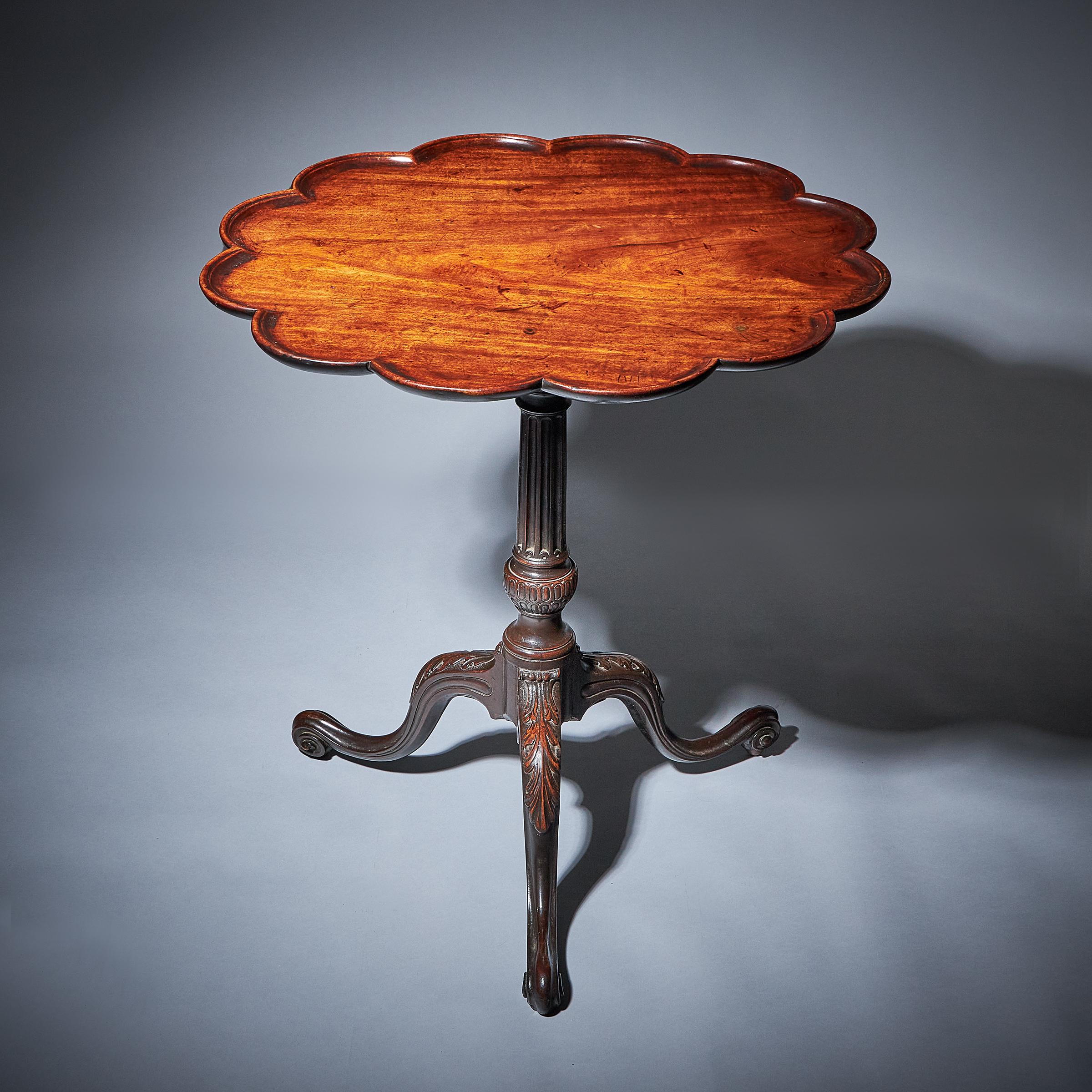 A Fine 18th century George III Mahogany pie-crust Tripod table with birdcage in the manner of Thomas Chippendale, c. 1760-1770. England

The moulded pie crust top sits above the original four gun barrel birdcage. 

The stop reeded fluted column