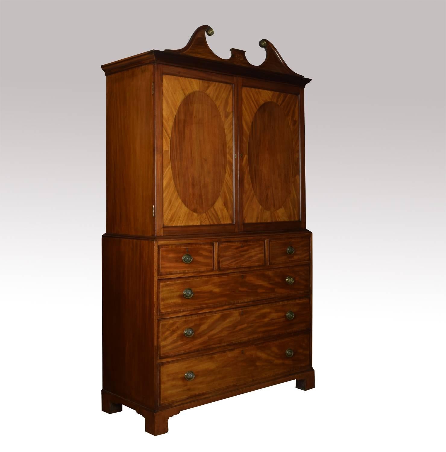 Fine 18th century George III period mahogany gentleman’s cabinet on chest with inlaid swan neck pediment above two oval panelled doors opening to reveal five graduated draws. The base section fitted with three short and three long graduated draws