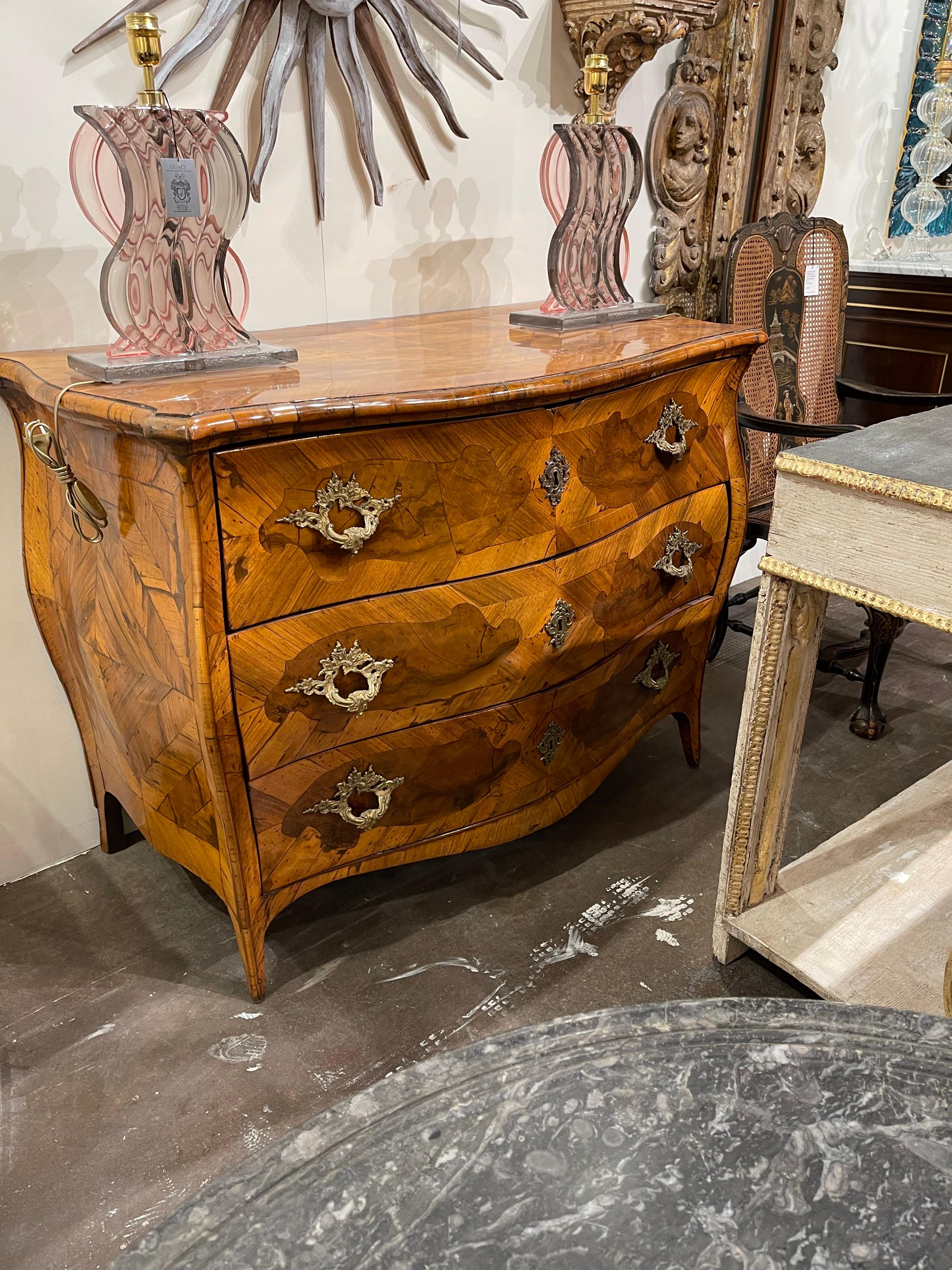 Outstanding circa 1780 Italian bombe and serpentine fronted commode with shaped burl walnut inlays on three drawers with fancy bronze pulls and escutcheons. Wonderful sleek corners flow smoothly onto slightly tapering legs.

Mellow yet rich patina.