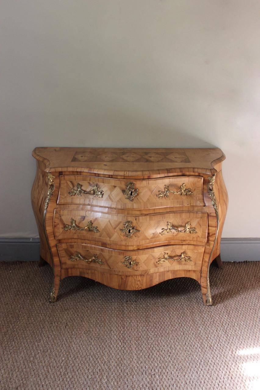 A fine quality and of great design, mid-18th century Swedish bombe commode in bleached elm, retaining the original ormolu mounts, that will make a statement in most settings.