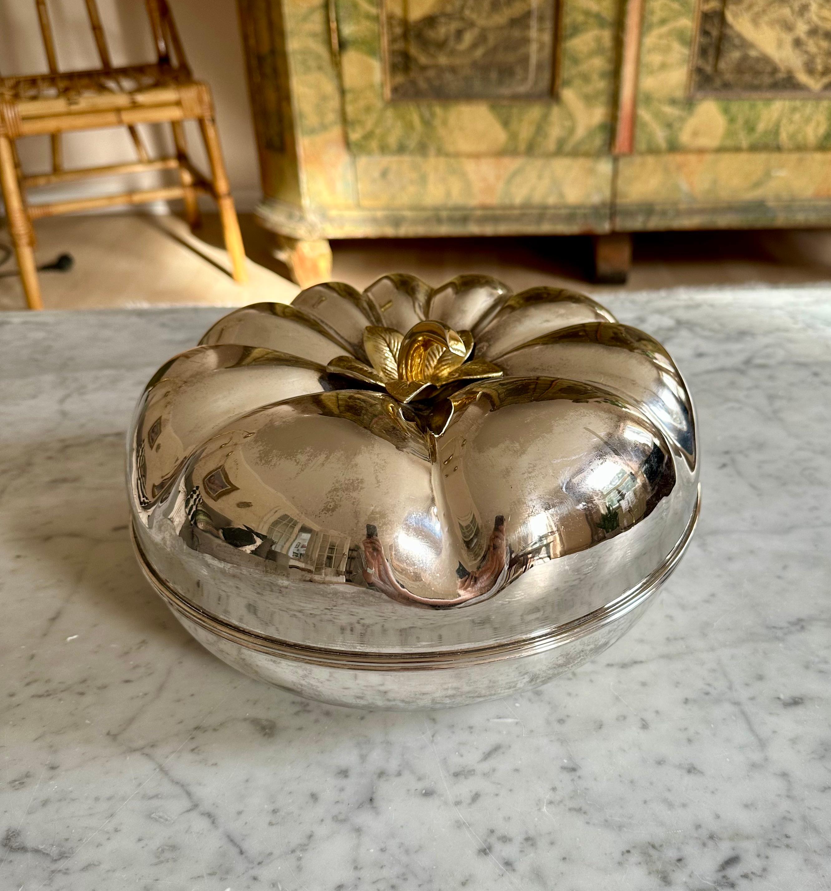 Transform your dining experience with a touch of vintage opulence embodied in this exquisite Italian offering bowl from the 1970s. Resembling the grandeur of a Hokkaido pumpkin, this piece is a true work of art, crafted from silver-plated metal. The