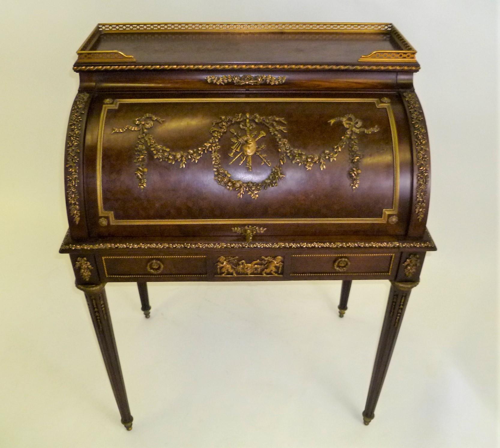 Exhibiting the sought after superior fineness of Francois Linke, this late 19th century petit Bureau a Cylindre or roll top desk is a splendid creation. Mahogany with a deep plum color and richly adorned with finely chased bronze mounts typical of