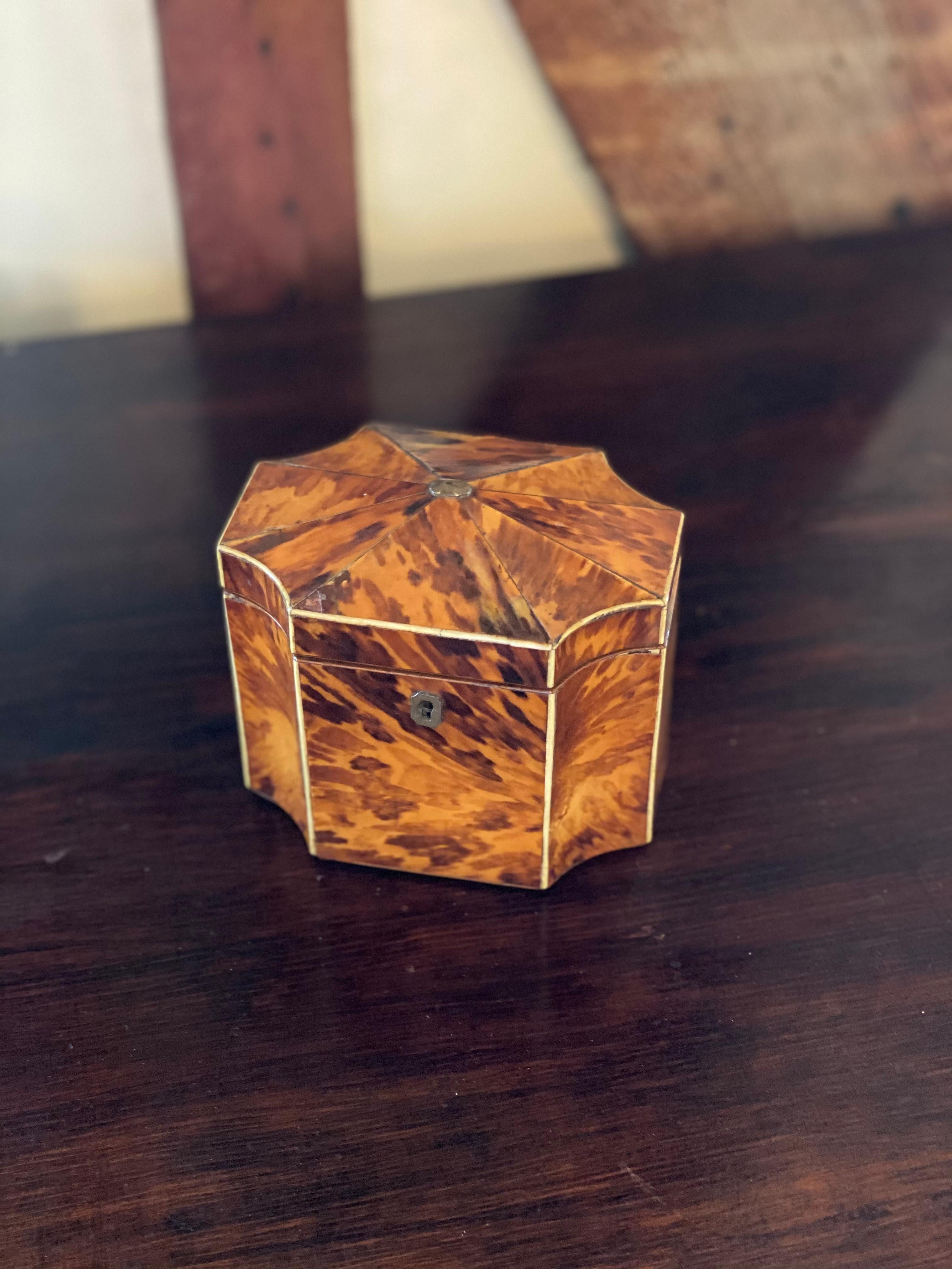 Fine 19th century English bone inlaid and shaped tortoise shell tea caddy with original fittings.