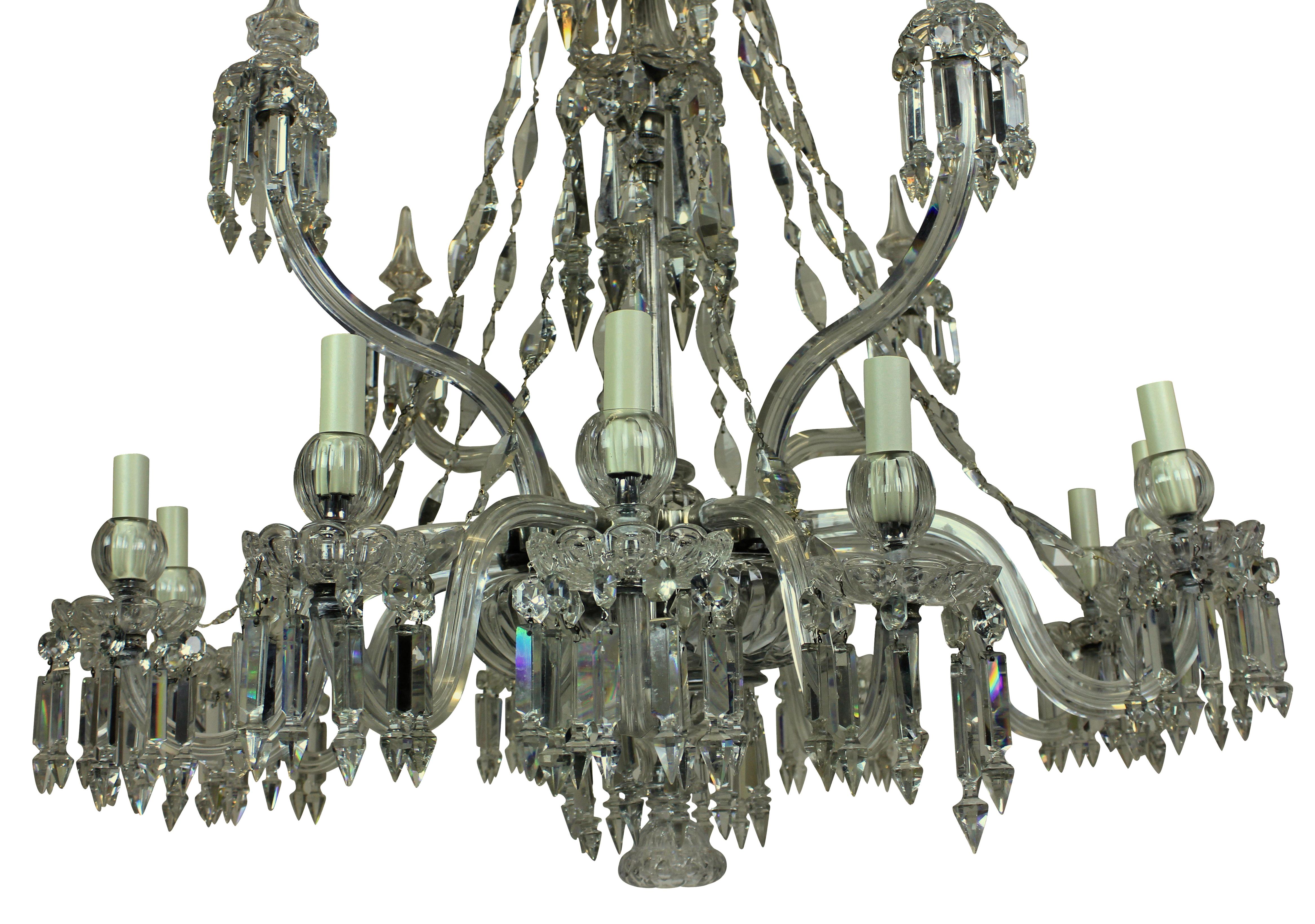 A fine English cut-glass chandelier by F & C Osler. Formerly a gasolier. With twelve arms hung throughout and four large up-swept arms with spikes. The chains of diamond shape are a unique Osler pattern.
  
