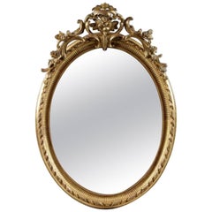 Raffinato specchio ovale francese del XIX secolo del periodo di Napoleone III in legno dorato intagliato