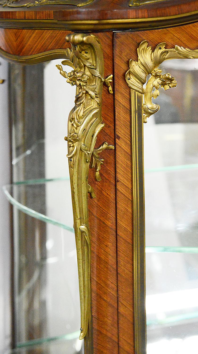 Vitrine de style Louis XVI de la fin du 19ème siècle en marqueterie de bombe, ayant son dessus en marbre Brèche Violette d'origine, de magnifiques montures en bronze doré ciselé et feuillagé, des étagères ajustables vitrées à l'intérieur, des