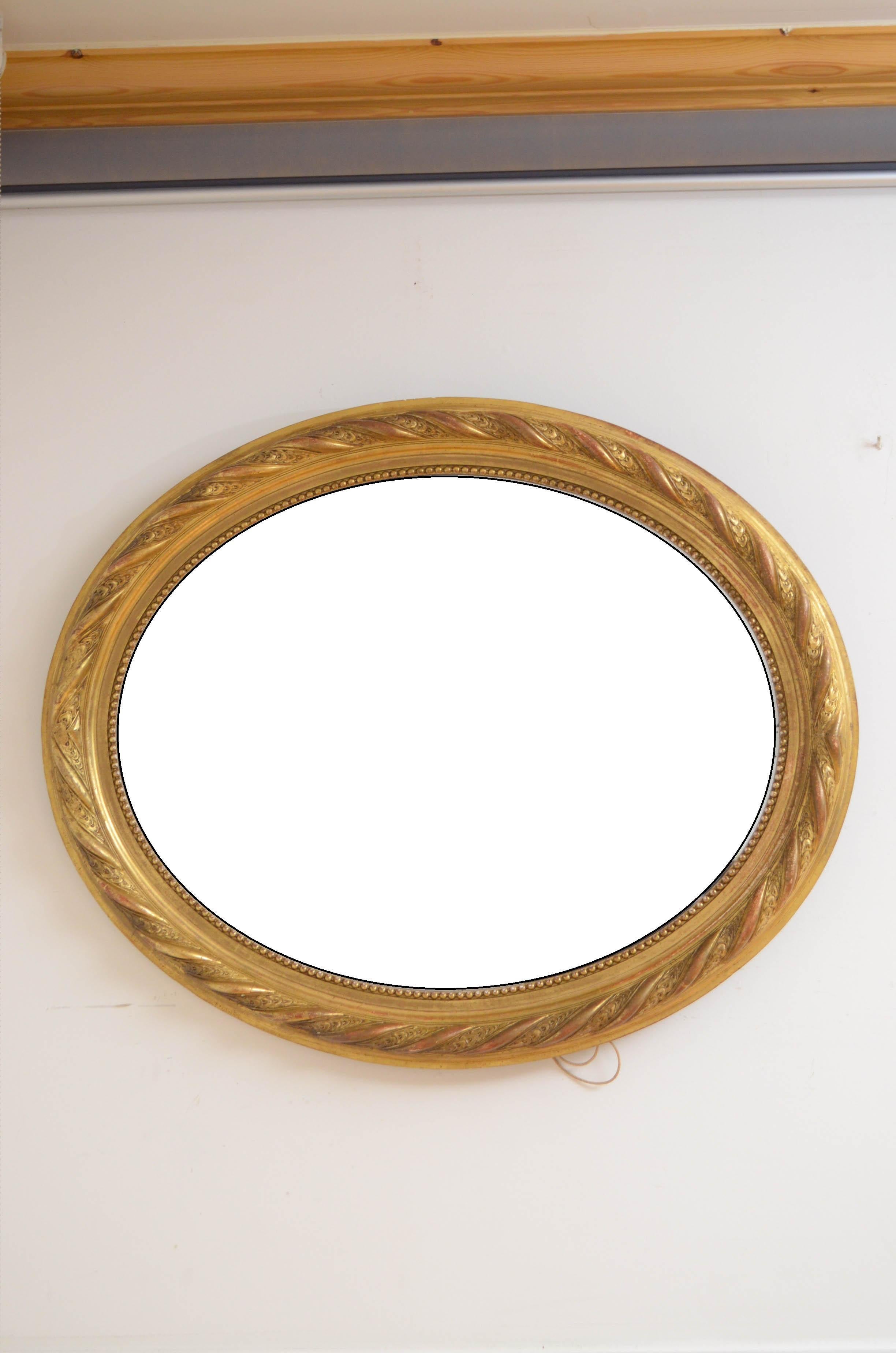 0583 Superb 19th century gilded wall mirror, having original bevelled edge glass with some foxing in beautifully carved and beaded giltwood frame. This antique mirror retains its original glass, original gilt and backboards, all in home ready