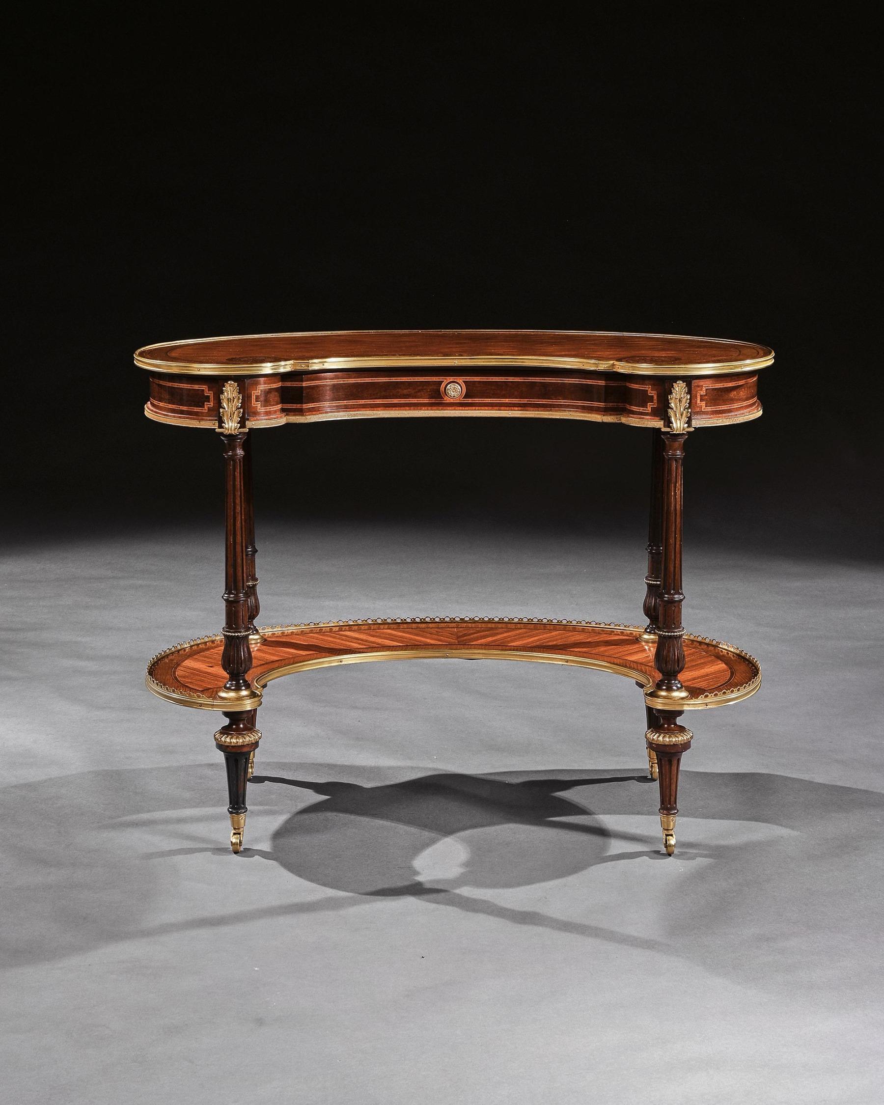 An extremely fine gilt bronze mounted parquetry kidney shaped writing table attributed to Gillows of Lancaster. 

English Circa 1865

The rosewood lozenge trellis inlaid kidney shaped top with finely detailed husks and paterae, banded with exotic