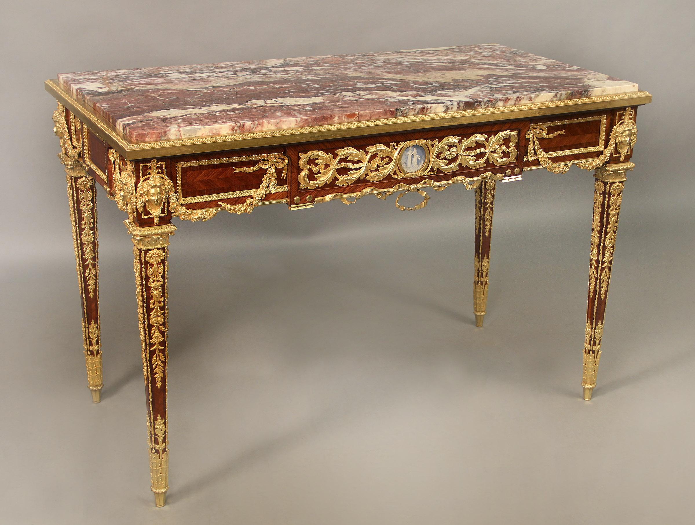 An Exceptionally Fine Late 19th Century Louis XVI Style Gilt Bronze Mounted Mahogany Center Table By Joseph Zwiener

Joseph Zwiener

The rectangular marble top above a frieze drawer, raised on square tapering legs, the whole cast with beautiful