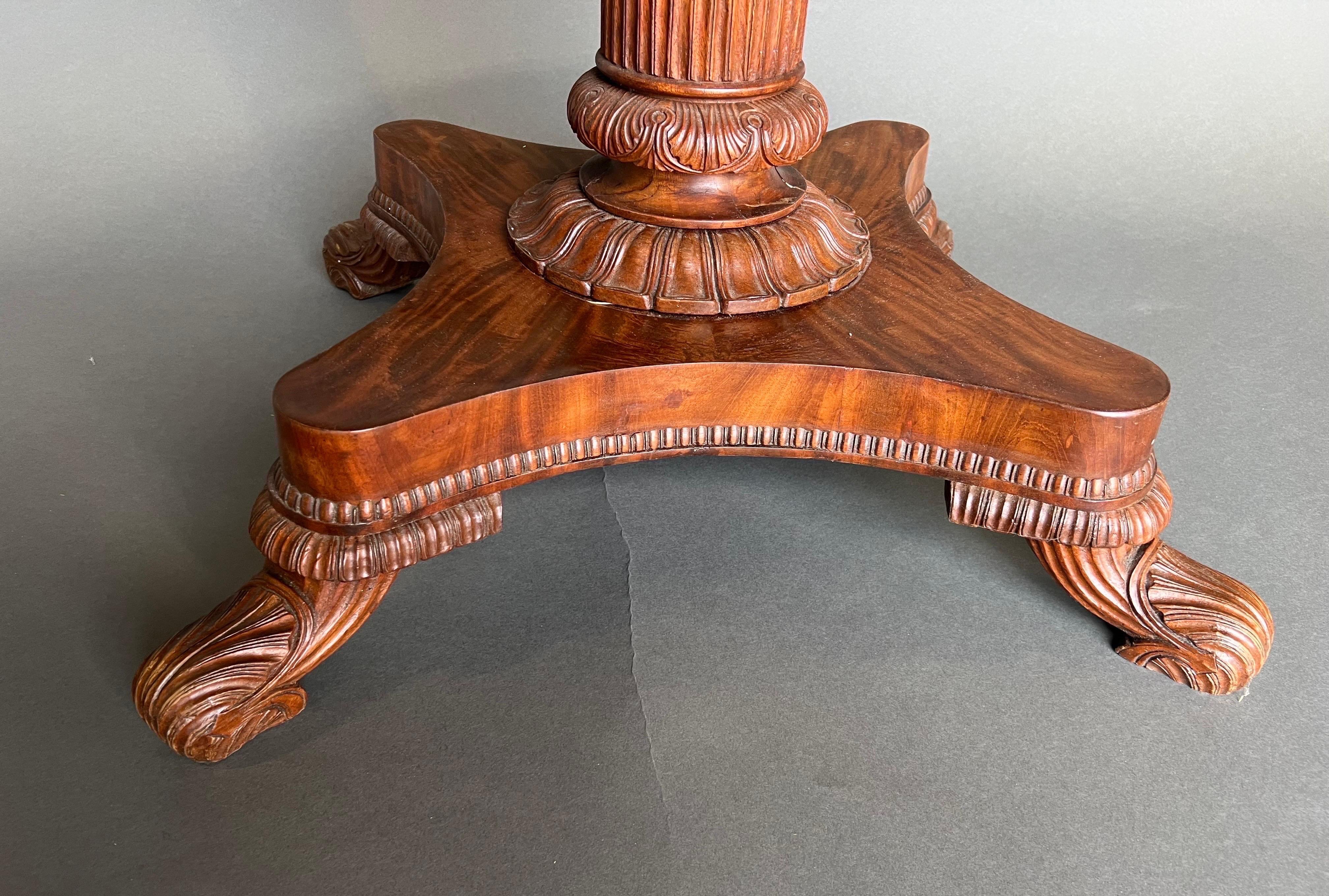 Fine 19th century Irish Regency period oval breakfast table. Good color and great quality timbers used in this period Irish table. Oval top over turned pedestal base supported on four finely carved feet.