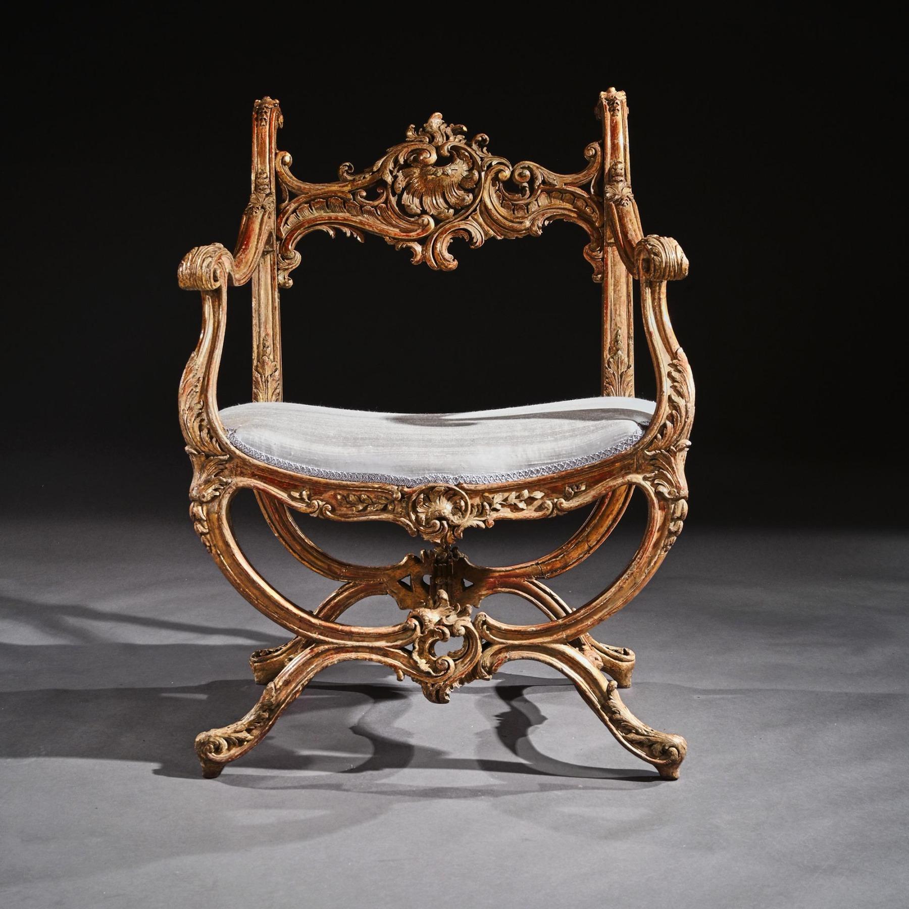Finely carved mid 19th century Italian giltwood open armchair of wide proportions in the Rococo manner.

Italy, Venice Circa 1860.

The asymmetrical scroll and leaf-carved top rail, centred on a stylised shell within over scrolled uprights,