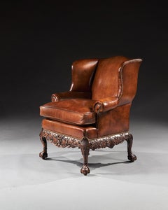 Fauteuil à dossier à oreilles tapissé de cuir d'acajou du 19ème siècle, style George I