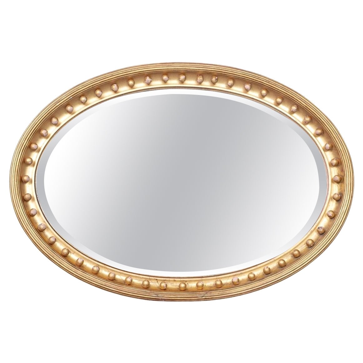 Miroir ovale biseauté et doré du XIXe siècle