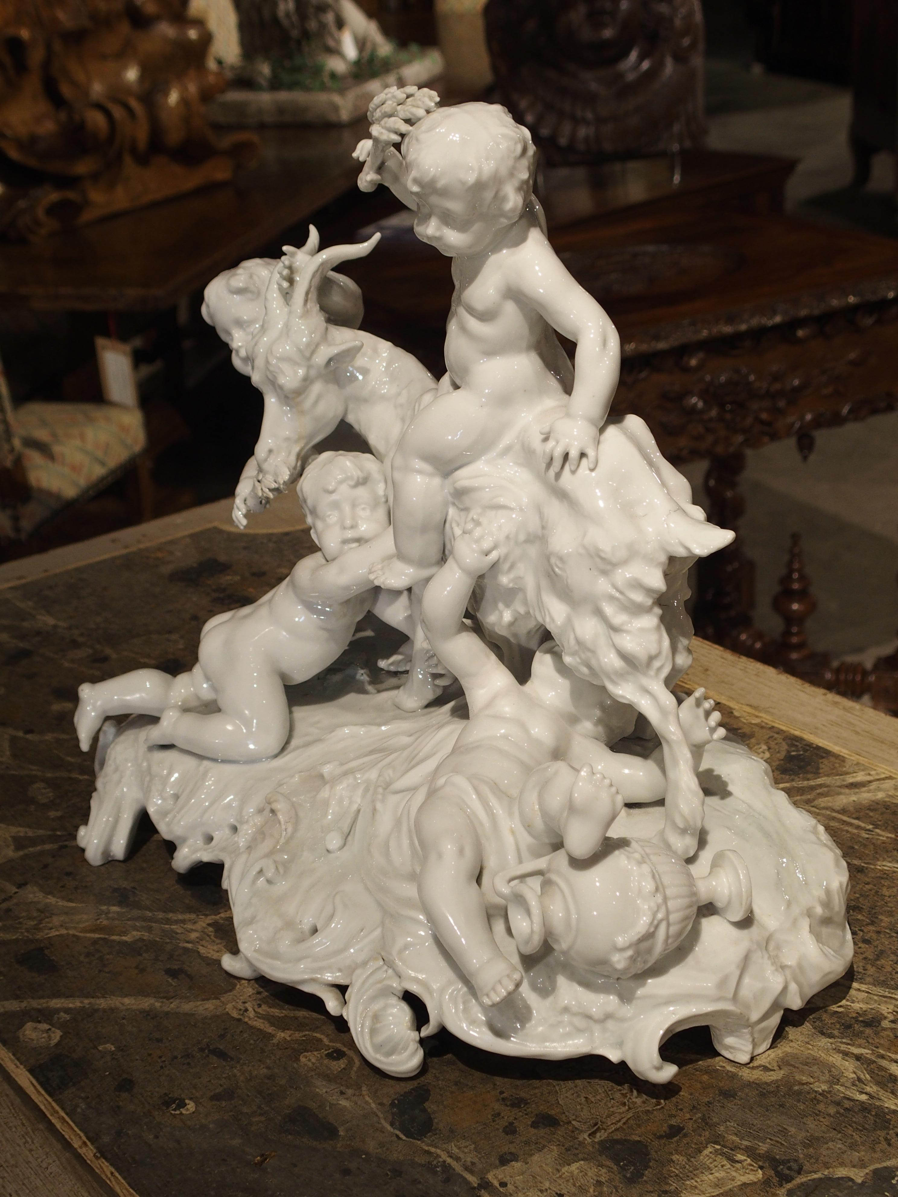 This bright Capodimonte porcelain group of four putti and a goat symbolizes abundance and the spirit of life. Capodimonte was originally an 18th century Italian porcelain company that made some of the finest figural pieces. Production has continued