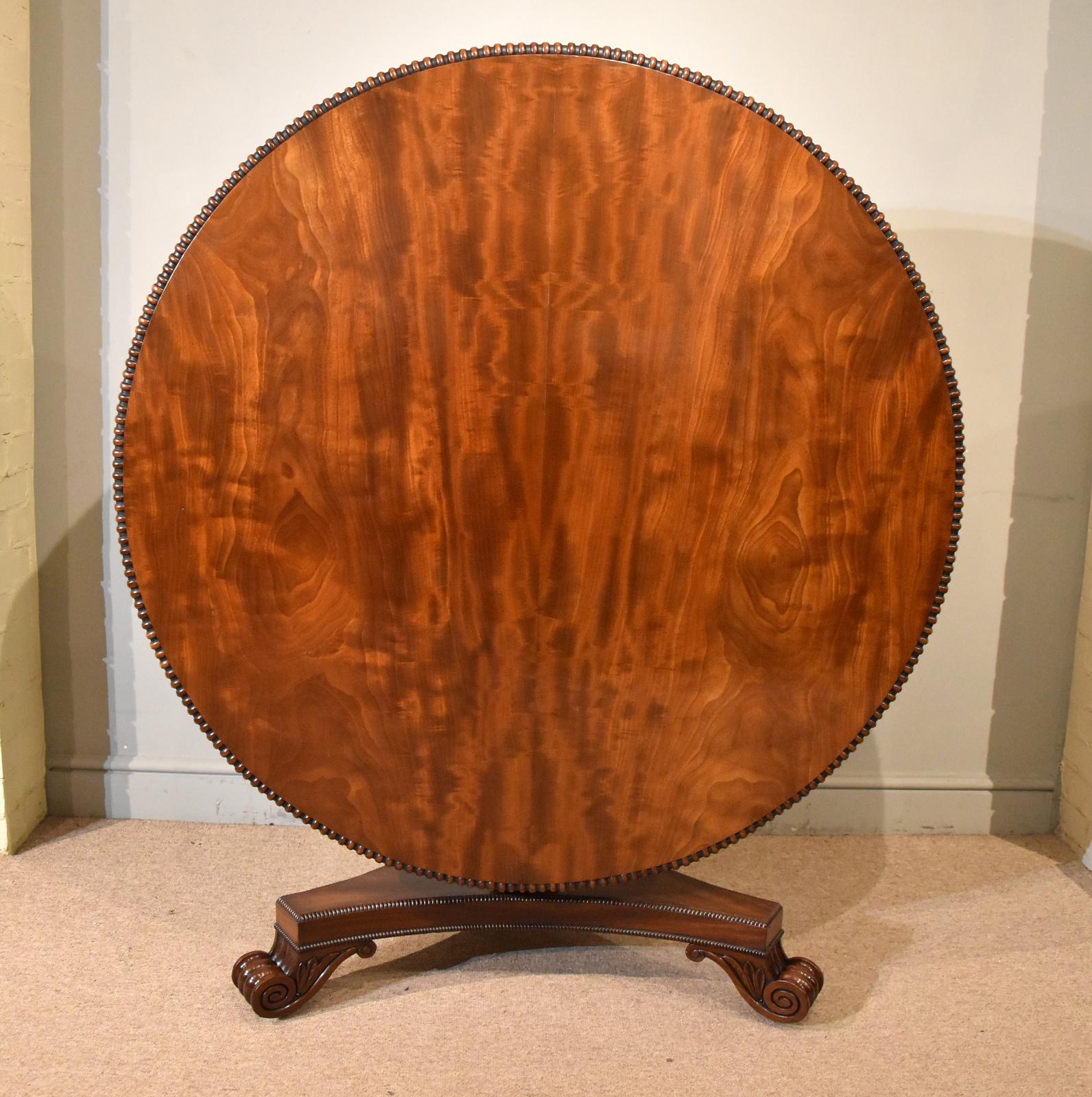 A fine, beautifully figured and elegant regency mahogany centre table of excellent proportions. Having a circular top, which can also be tilted and kept in the upright position, made from the finest Cuban mahogany surrounded by a gadrooned edge,