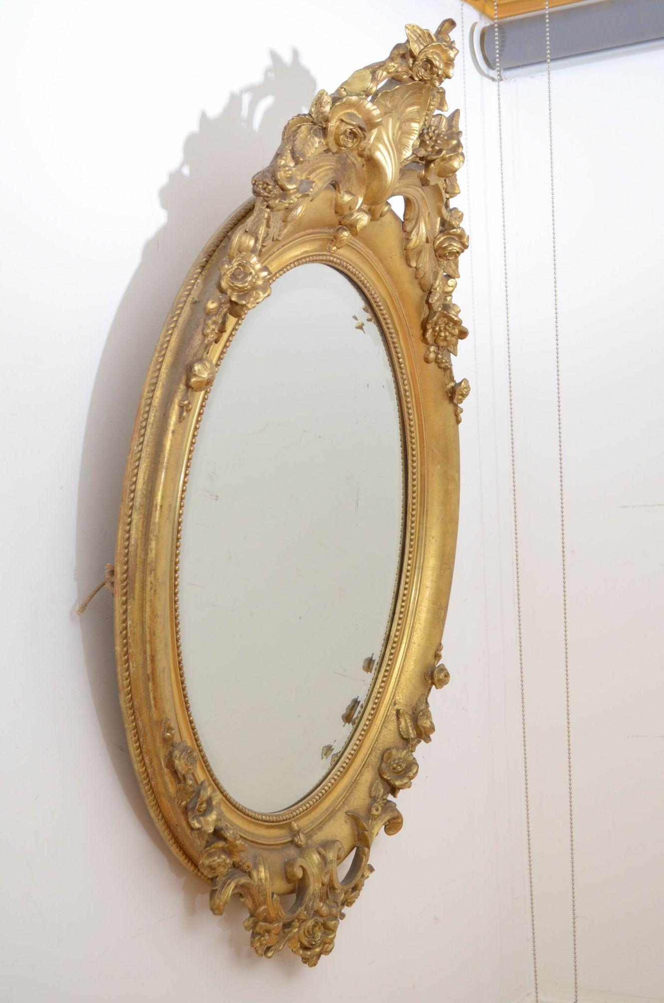 Sn5396 Superb XIXth century French gilded wall mirror, having original bevelled edge glass with minor imperceptions in moulded and beaded giltwood frame with shell crest to the centre flanked by floral swags, the base with floral crest and scrolls.