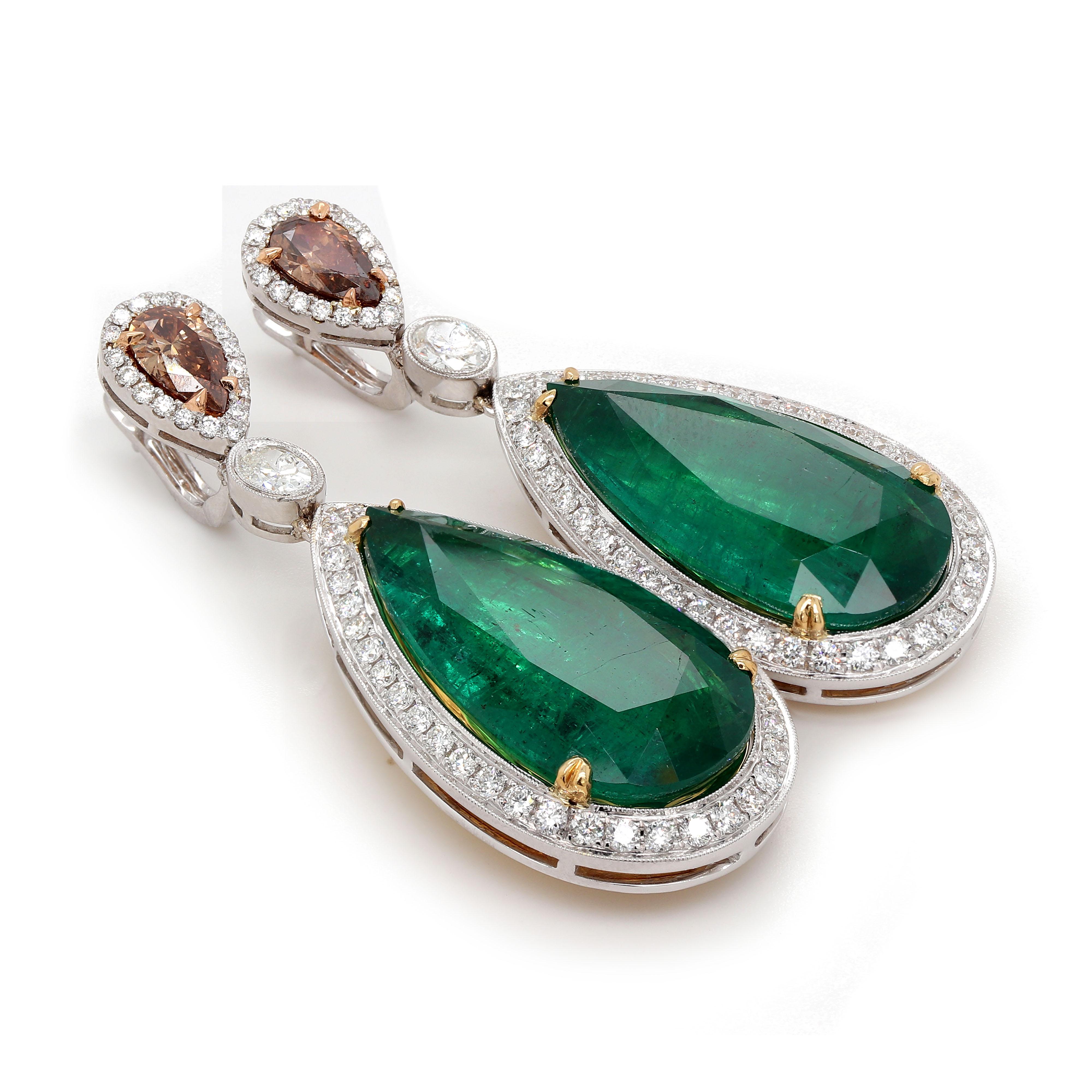 Dangle earrings includes 2 pear shape Emeralds of about 33.07 carats and 2 pear shape brown diamonds of about 1.35 carats. It also includes 2 oval shape diamonds of about 0.61 carats with a Clarity VS and Color G. They are surrounded by 112 round