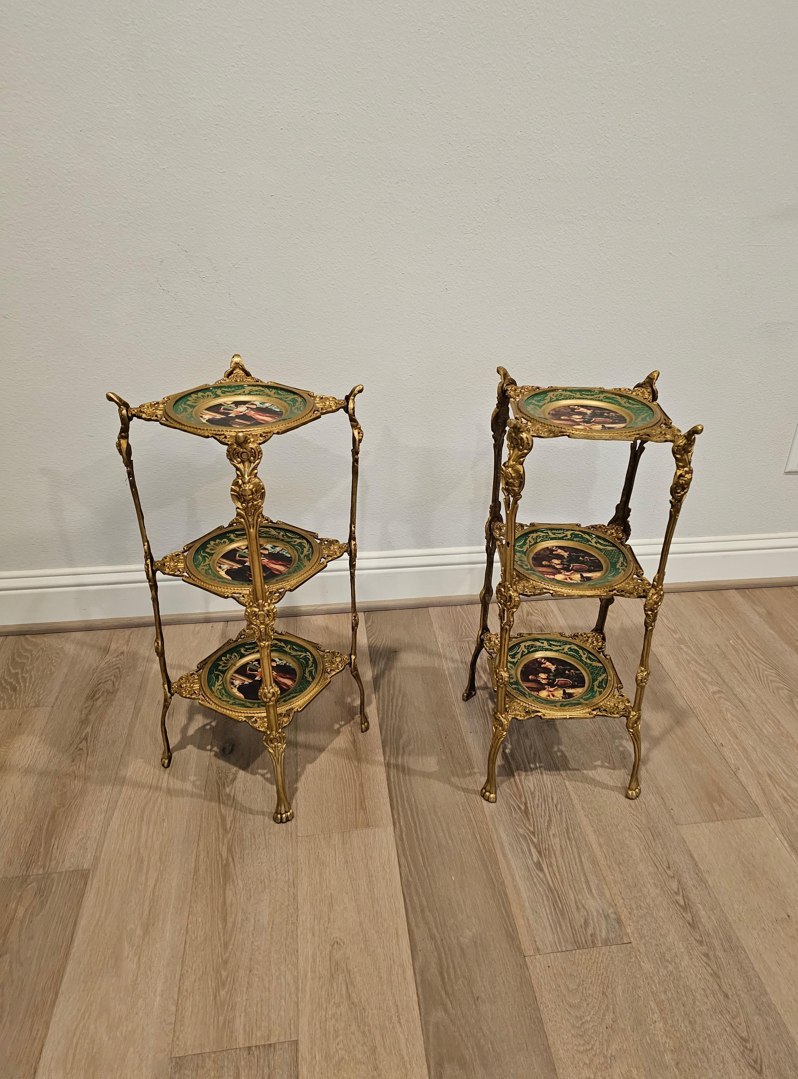 A pair of fine gilt bronze ormolu mounted porcelain tiered étagères. Decedent French Aesthetic Movement styling, circa 1890, brilliant bronze doré supports, three Victorian hand painted parcel gilt porcelain dish-form tiers. 

Ideal size for use