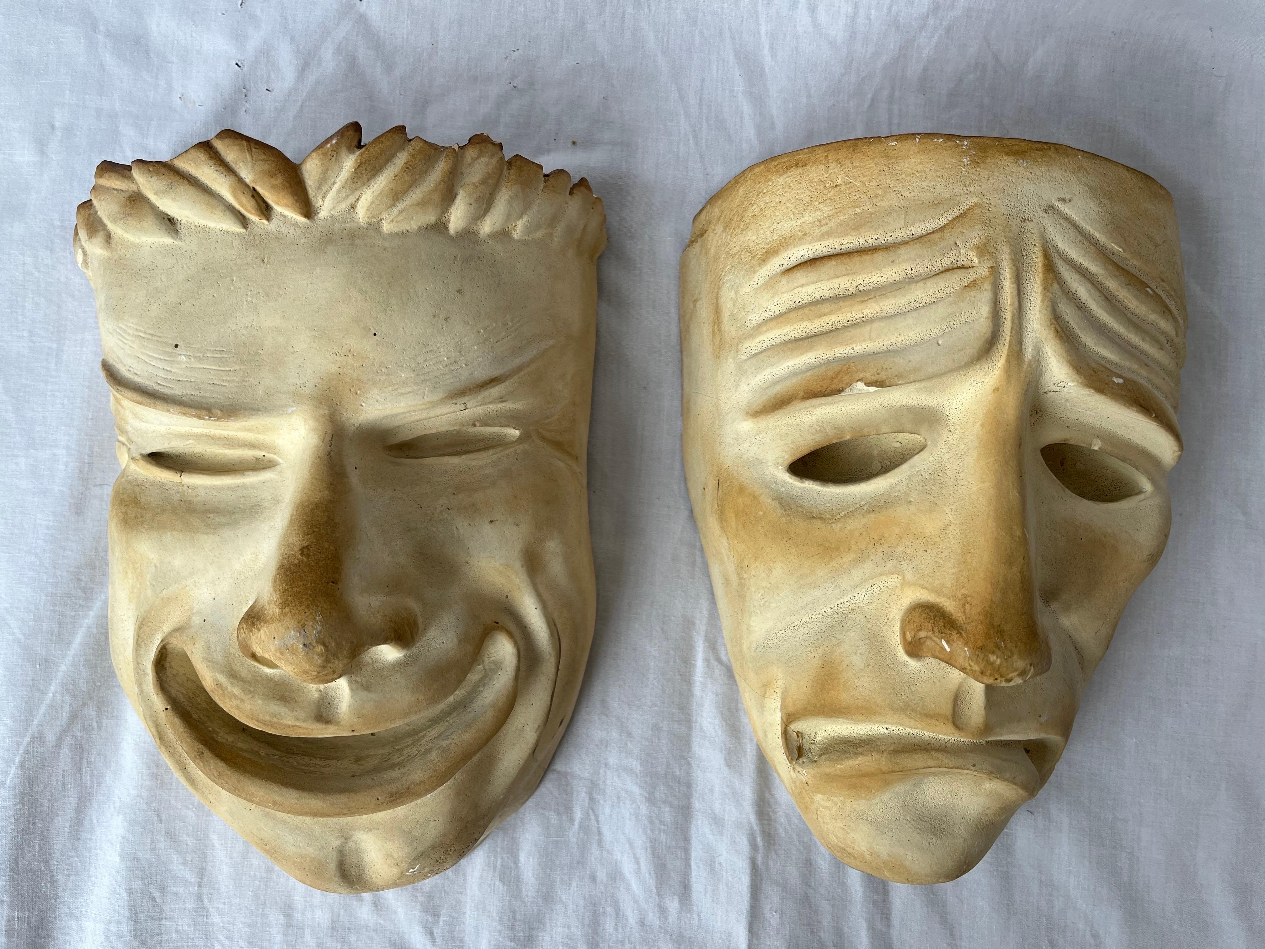 An almost antique pair of plaster comedy and tragedy theater masks. With incredible details, ultra-expressive countenances and wonderful scale, this duo evokes all the emotions. The plaster forms each have beautiful patina. There are integrated