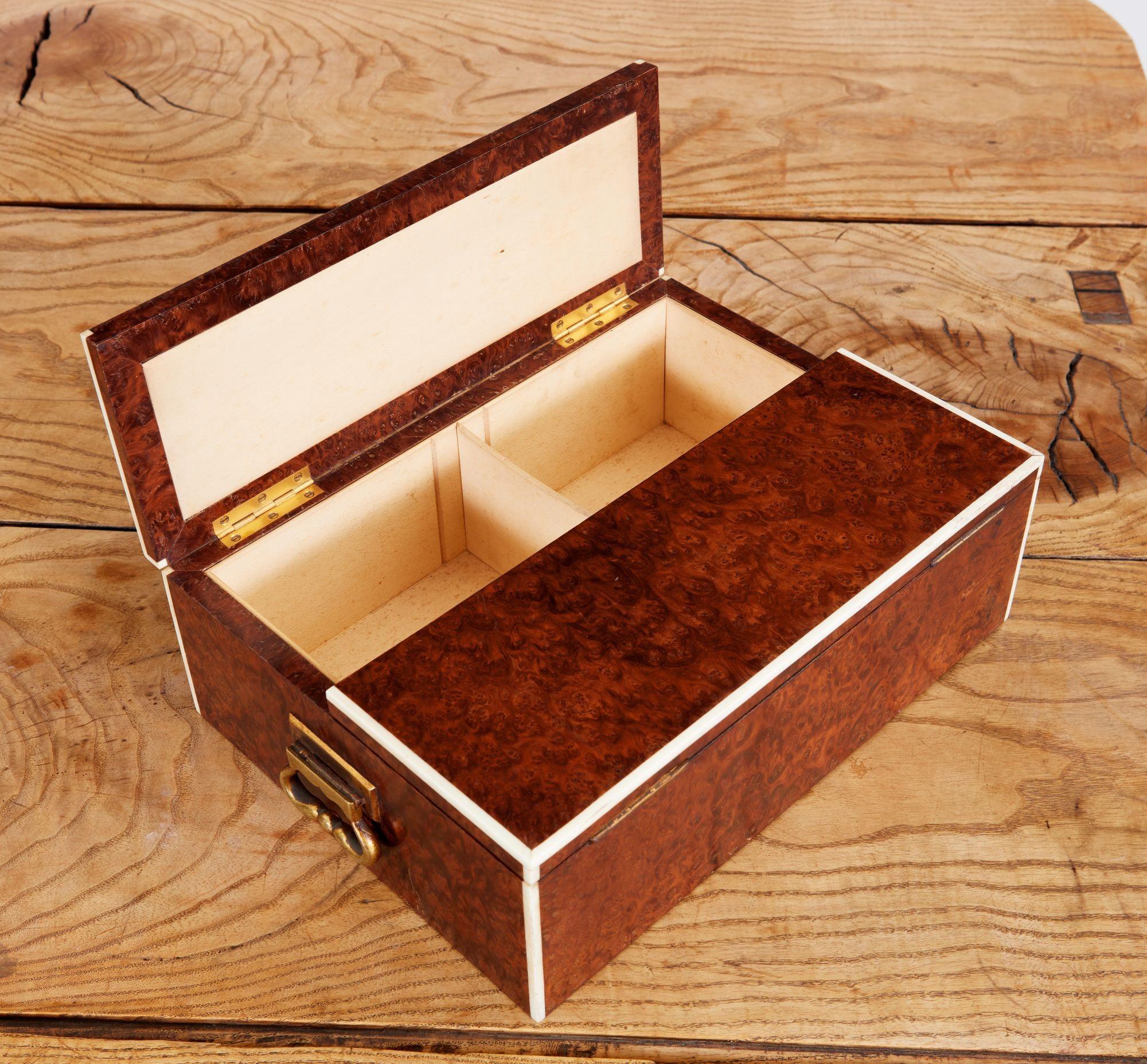 Very fine early 20th century humidor fashioned from solid amboyna burl with bone trim and lacquered brass carrying handles, by Callow of Mount Street, having sycamore lined interior, the underside with inset label reading 
