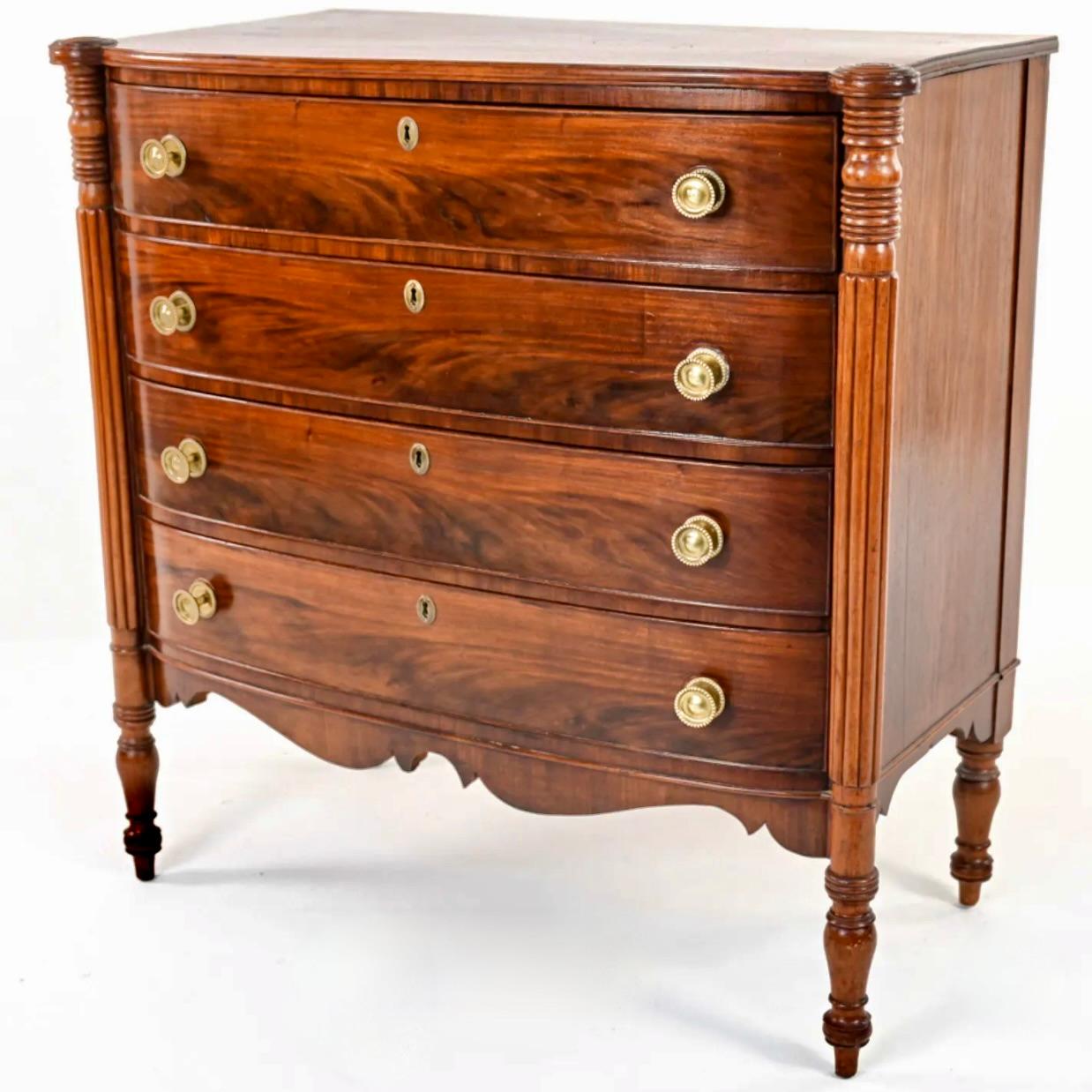 A very fine example of a Boston area Sheraton mahogany chest of drawers, with turret corners and reeded stiles on tall legs, giving the piece a sporty and well proportioned look. In gorgeous condition, the top is a single board of figured mahogany