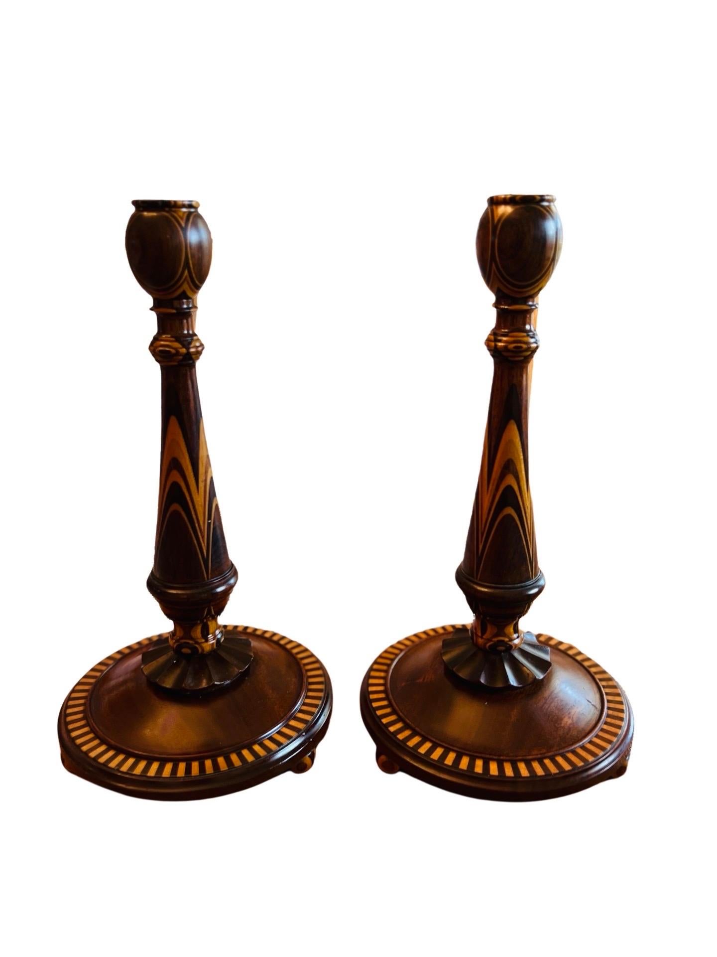 Fine American Turned Walnut & Mixed Marquetry Wood Candlesticks circa 1925

Each candlestick is finely crafted in a mix of walnut, mahogany, oak and other quality woods. Sculptured with inlay across the surface, a scalloped skirt and terminating