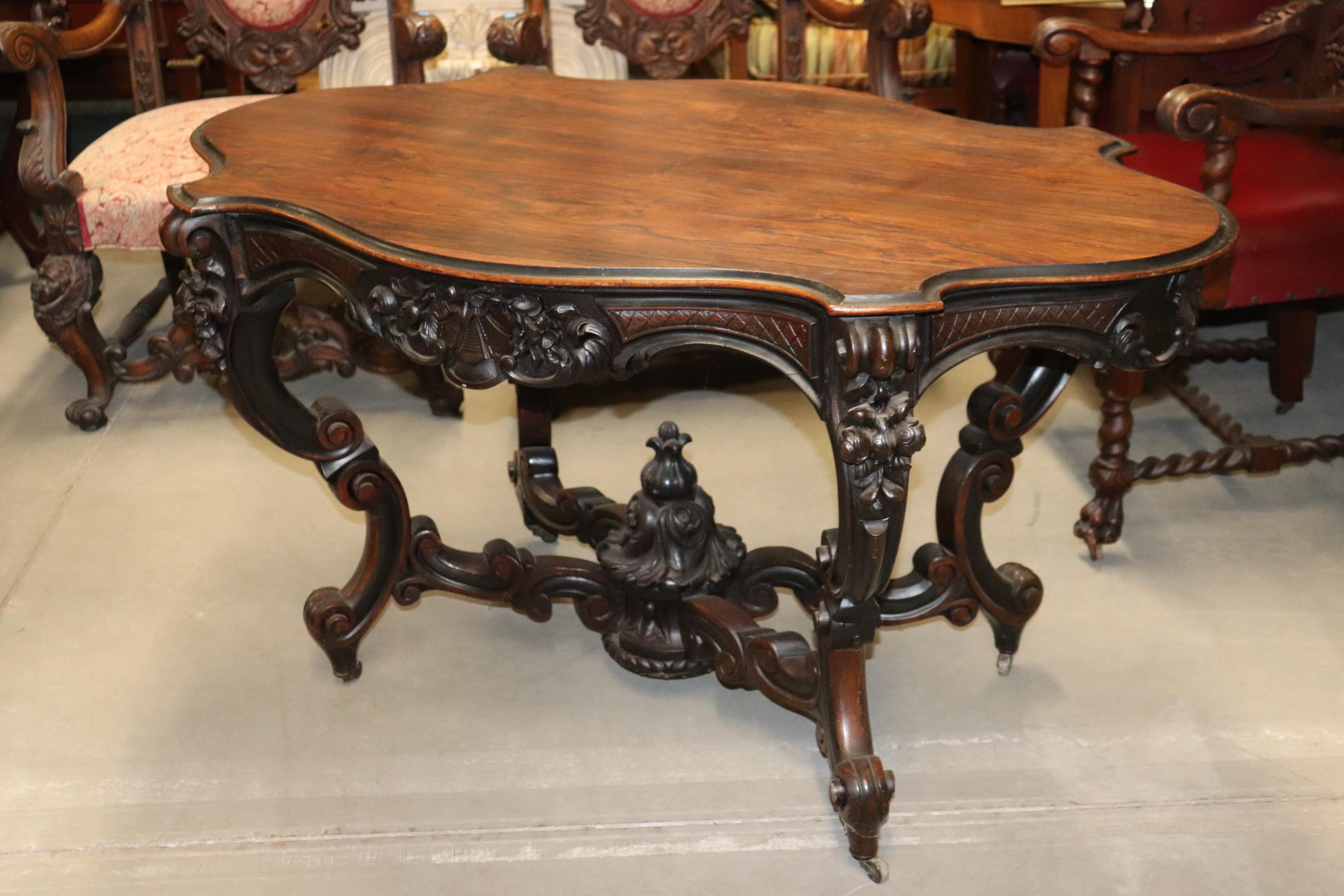 Made in the style of Meeks, this gorgeous American Victorian rococo center table features a fine original finish and beautiful design and wood quality. The table measures 56 wide x 34 deep x 30 tall. Dates to the 1860s era.