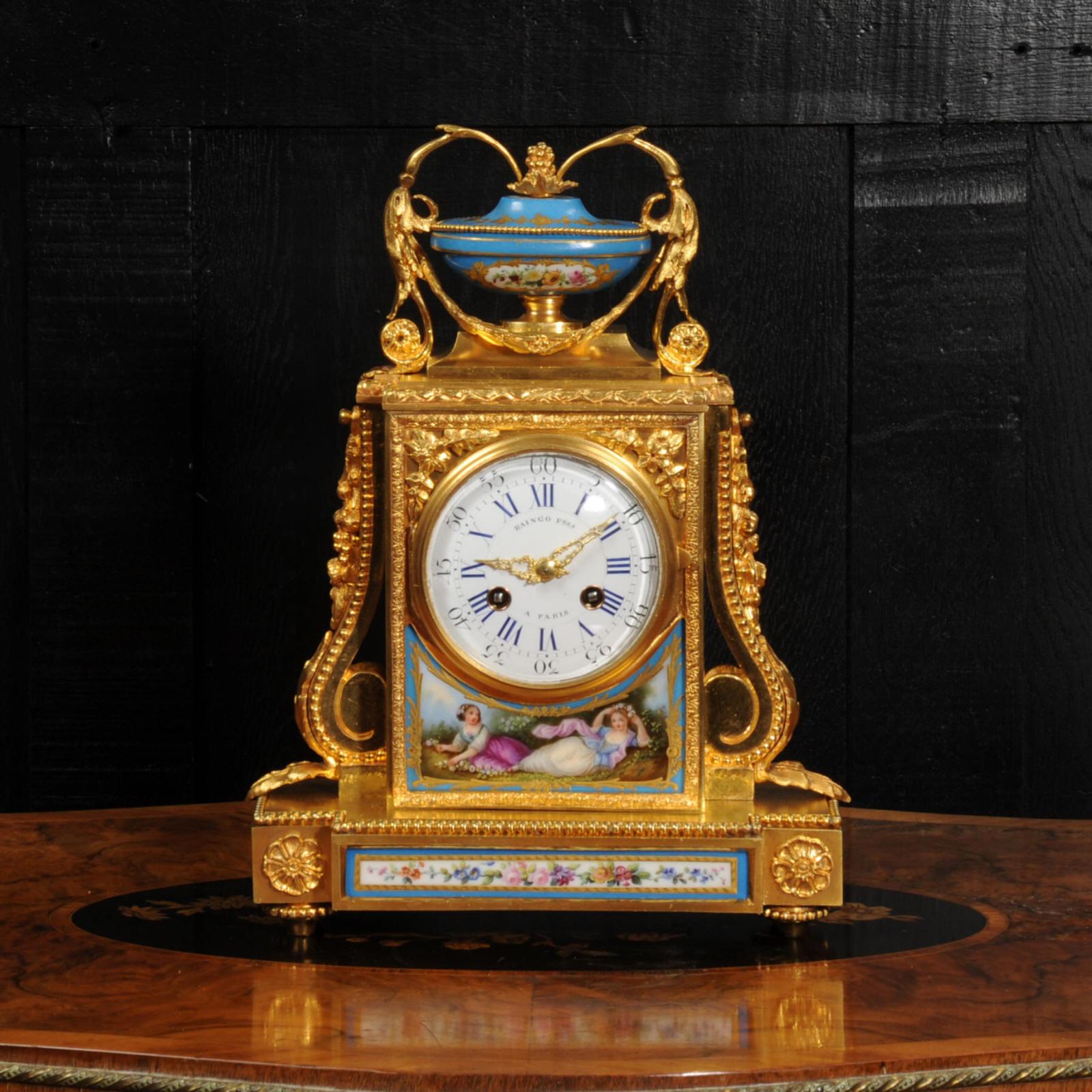 A fine and early clock, the case by Henri Picard of Paris and the movement by Raingo Frères. It is made of exquisite ormolu (finely gilded bronze) mounted with delicately painted Sèvres style porcelain with a blue ground. The panel below the dial is