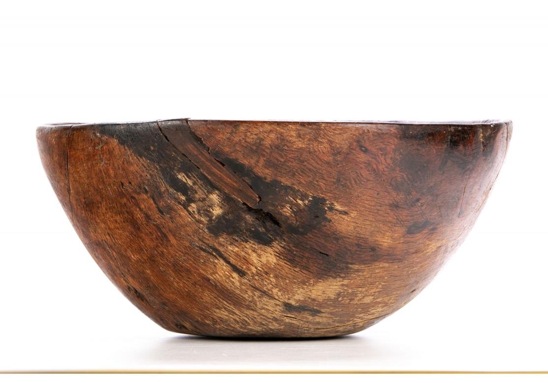 A large and rare antique hand carved burl wood bowl with rustic  form, fine tight graining and excellent age/ use patina. Possibly Native American, the bowl has very good aging and is in original condition with a soft hand indicative of much use.