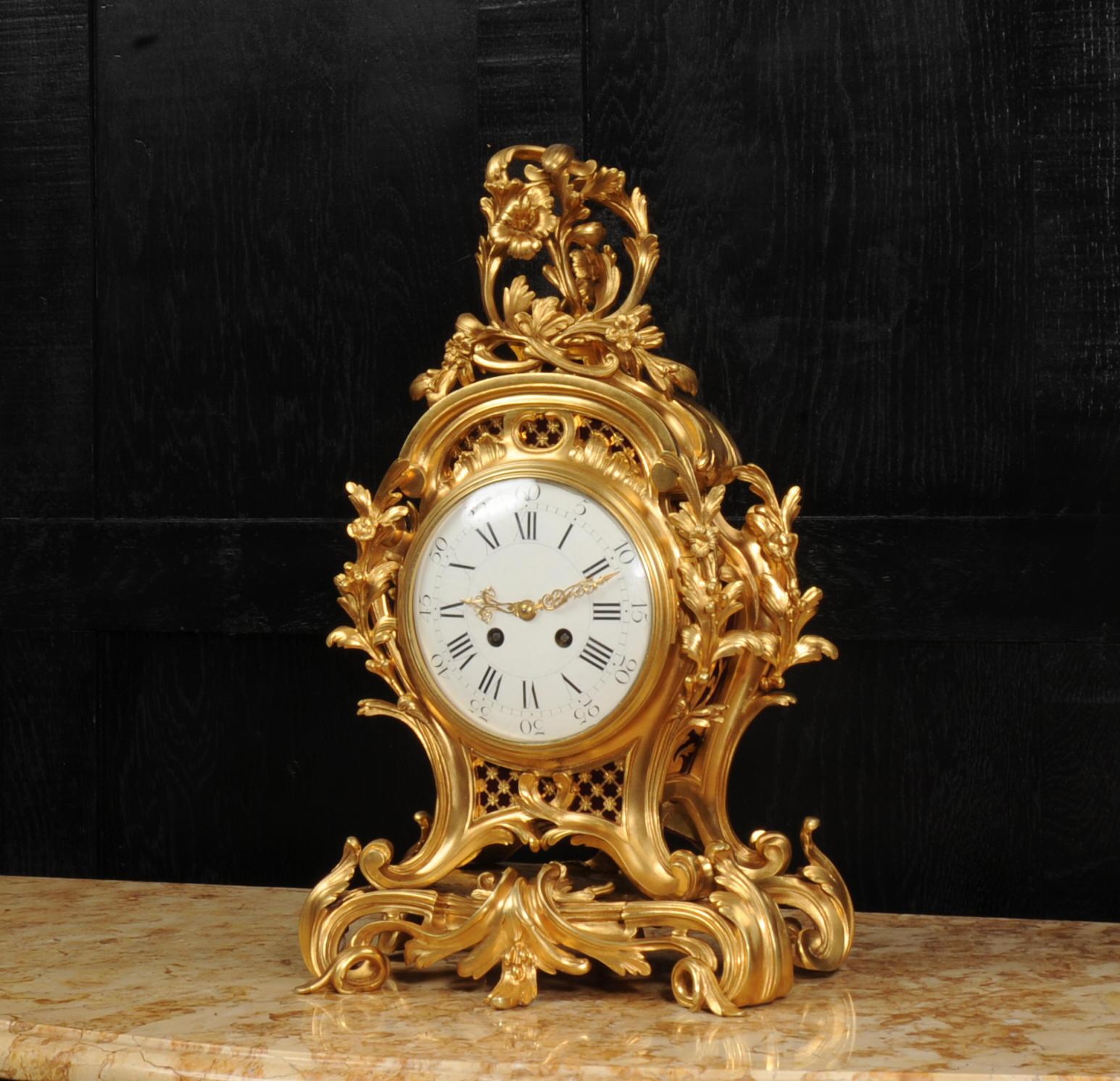 A substantial and very fine quality ormolu Rococo clock by Samuel Marti. Formed in finely gilded bronze, bold, sinuous scrolls and curves form the case with delicately modelled floral and foliate decoration. It stands on an integral naturalistically