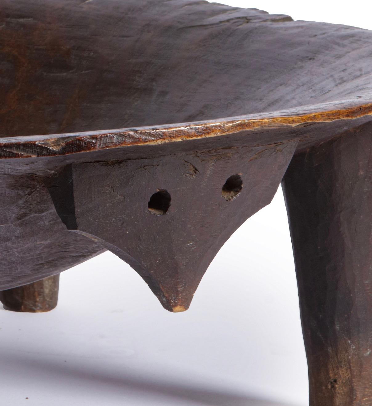 A fine and large Fijian Kava bowl or tanoa

Polynesia, early 19th century

Overall with a very attractive dark brown patina and traces of usage.

Diam. 64 cm

The bowl on four legs was used to make kava, with a 'mask' to the front for