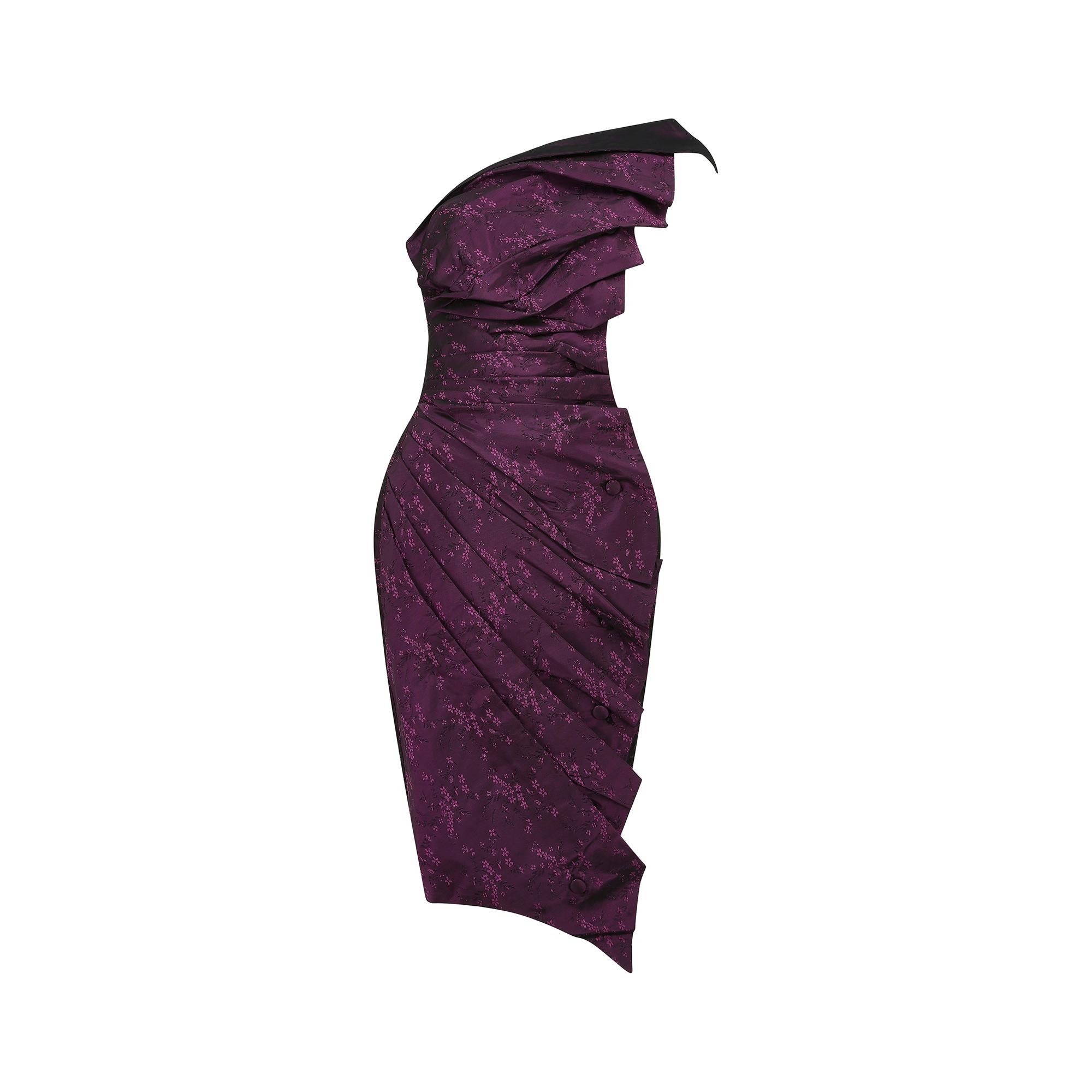 Fine and rare 1986 'bird dress' by legendary British designer Antony Price who created some of the most exclusive and glamourous evening wear of the 1970s and 1980s. The fabric is a glowing plum hued floral jacquard silk which catches the light and