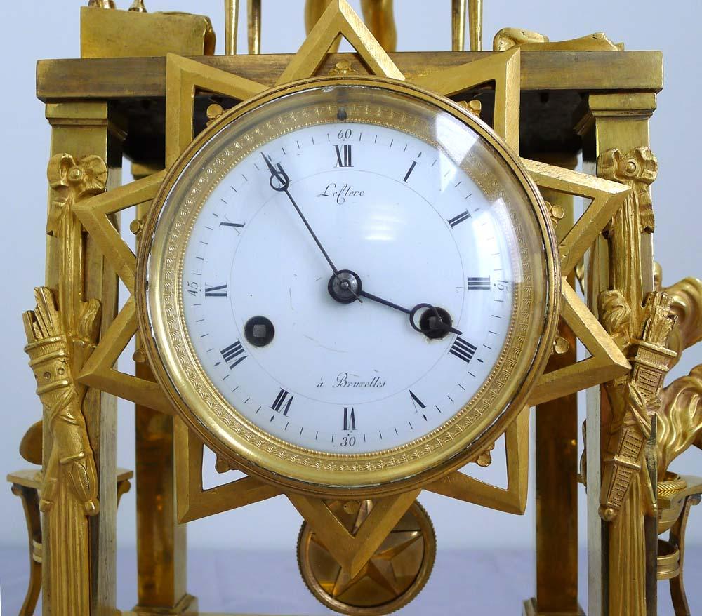 Early 19th Century Fine and Rare French Empire Clock of Cupid as Magician Uncovering Flaming Hearts For Sale