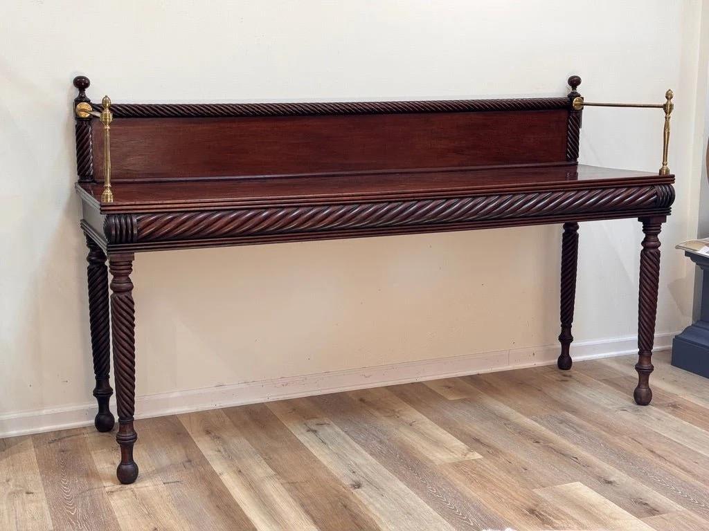 Fine and rare Irish server, sideboard, likely Dublin c. 1790-1810.  Cuban mahogany. The backsplash, apron and legs carved with deep, continuous, diagonal flutes in a uniform spiral pattern.  This table strongly aligns with the work of Mack, Williams