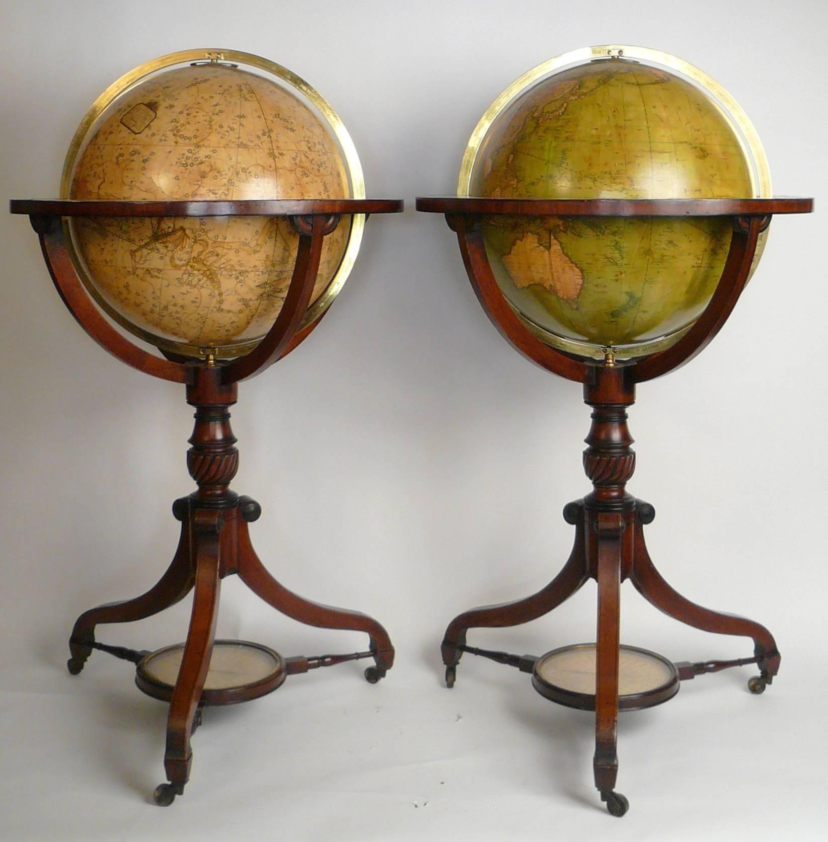 These fine terrestrial and celestial spheres, in brass meridian and horizon rings are supported by four arms, on gadrooned, and ring turned mahogany columns. Terminating in tripod spade feet, the turned stretchers incorporate a brass bezeled
