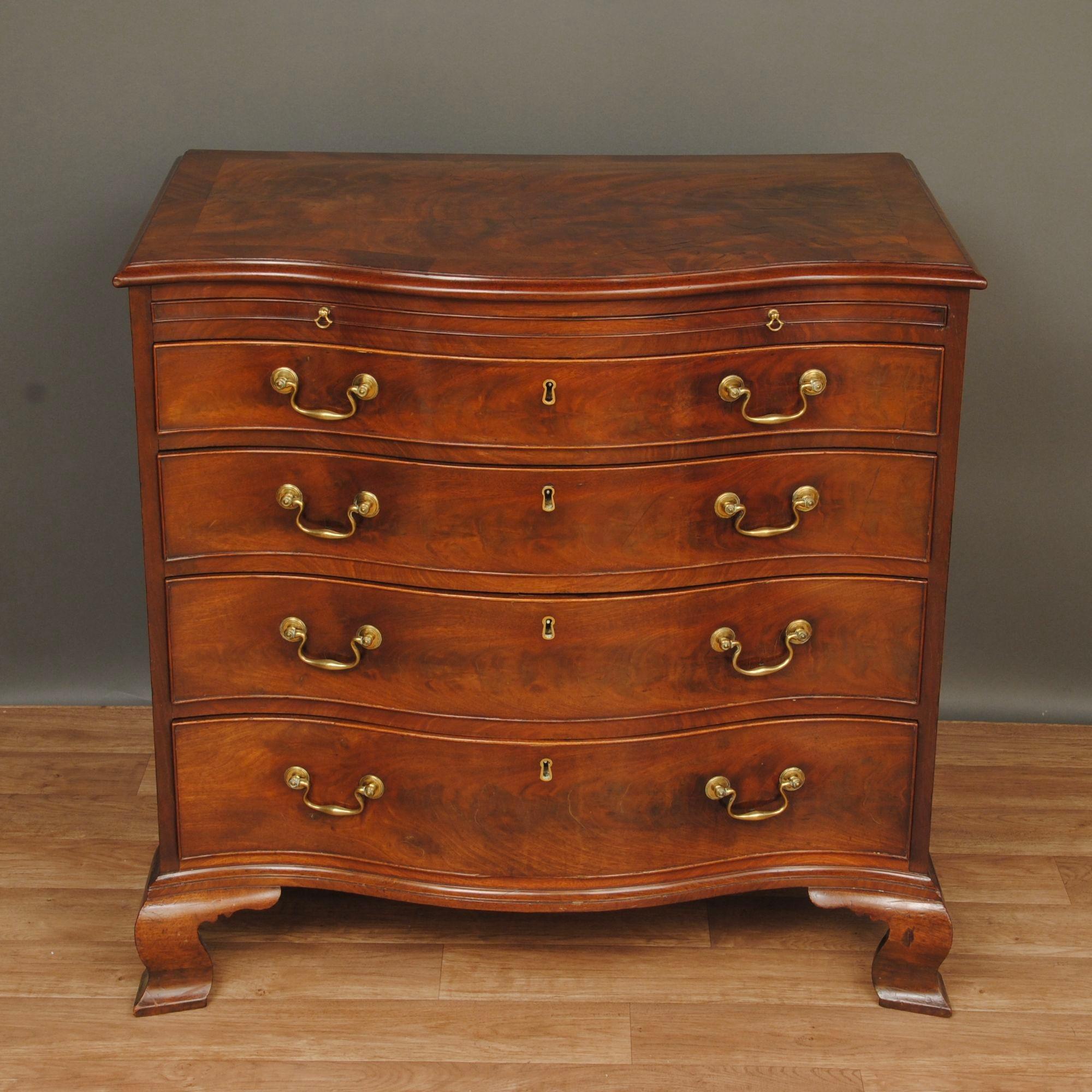 A super example of a flame mahogany serpentine chest with original swanneck handles and ogee bracket feet. The top with a large cross banding and lovely grain to the timber.
The whole piece with fine colour and superb patination.

From a fine